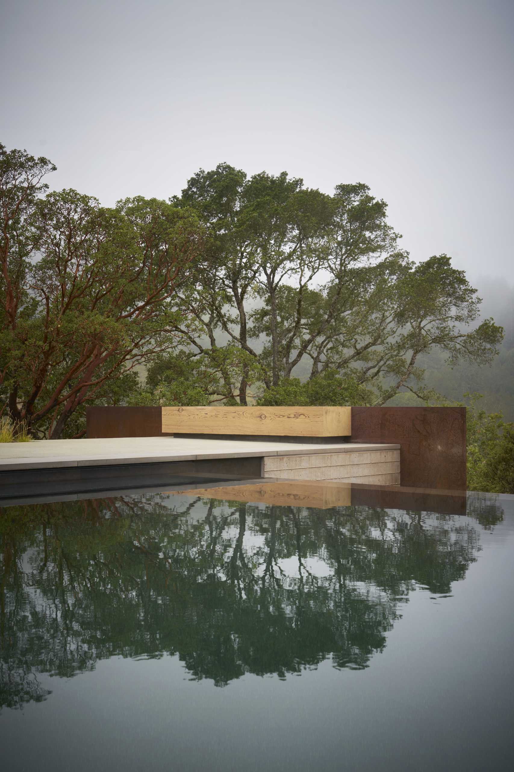 A modern home with a pitched ceiling, exposed wood beams, and expansive outdoor living spaces.