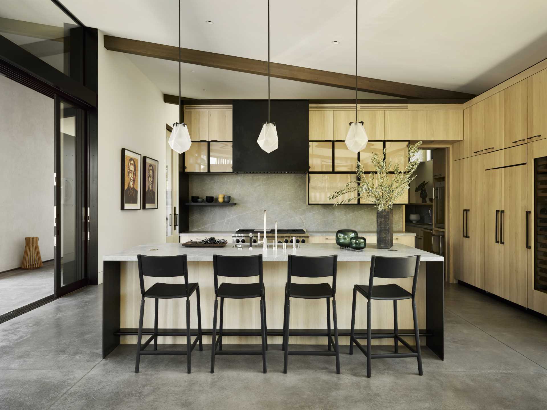 This modern kitchen includes wood cabinets, an island, and a separate walk-in pantry.