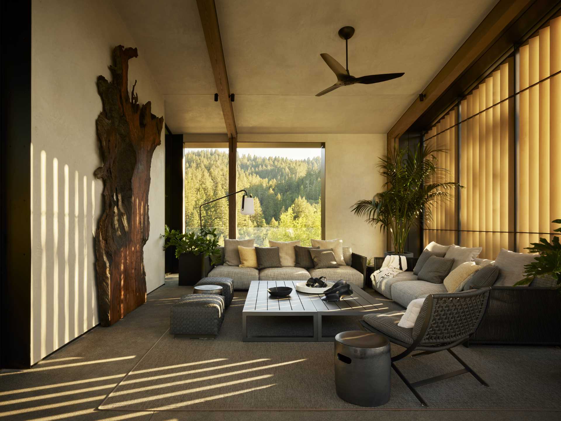 A modern home with a pitched ceiling, exposed wood beams, and expansive outdoor living spaces.