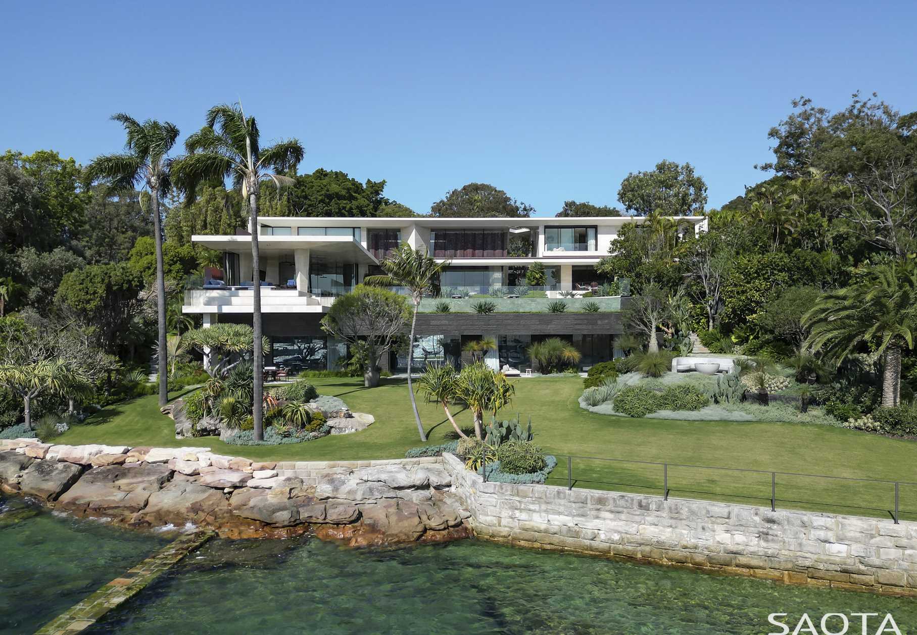 This modern home features Lava stone cladding, Honed Mount White Sandstone, Weathered Copper, and Bronze Aluminium, all of which are inspired by the surrounding area.