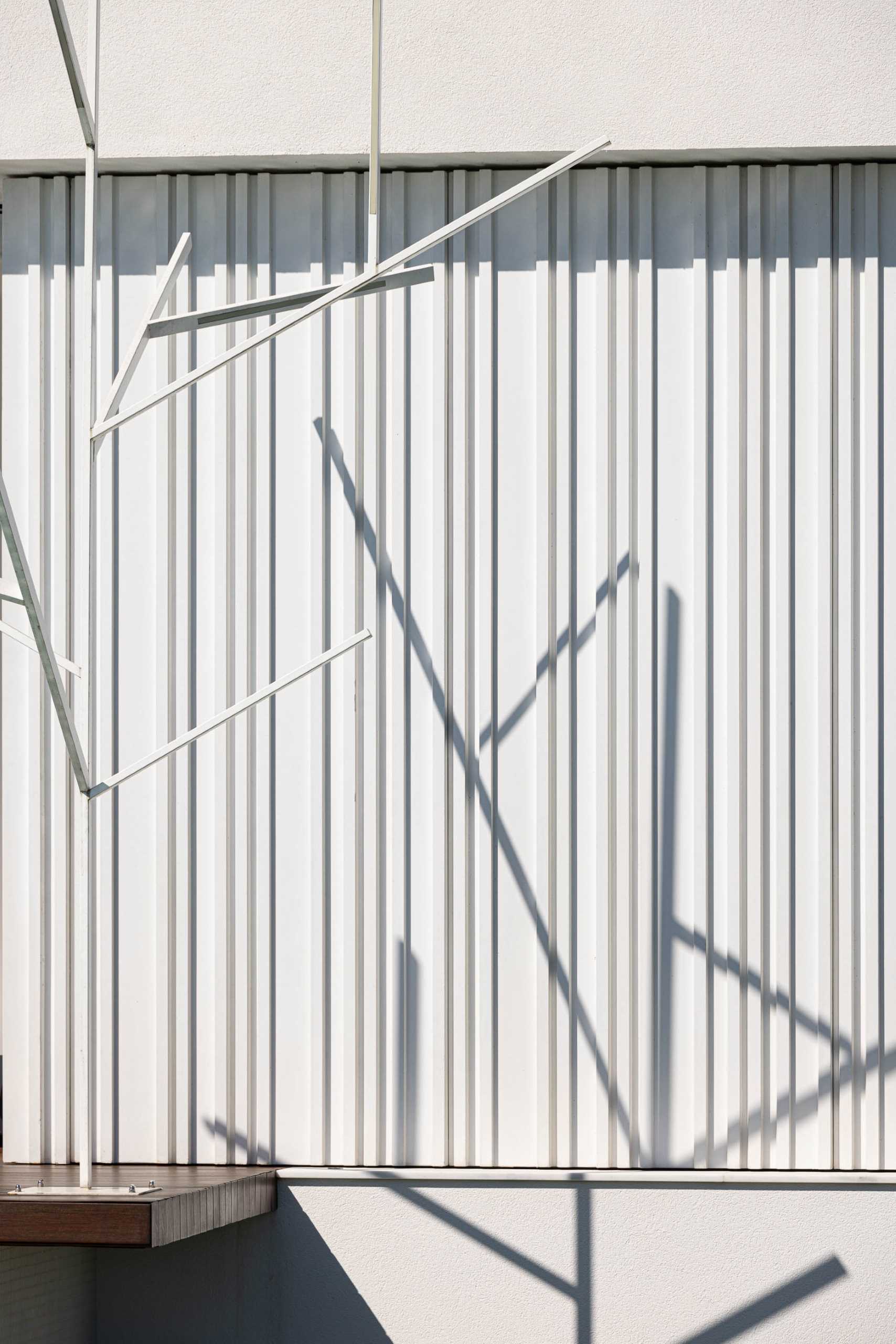 Here's a close-up look at the vertical stripes that cover sections of this modern home, while the depth of the lines is highlighted by the shadows.
