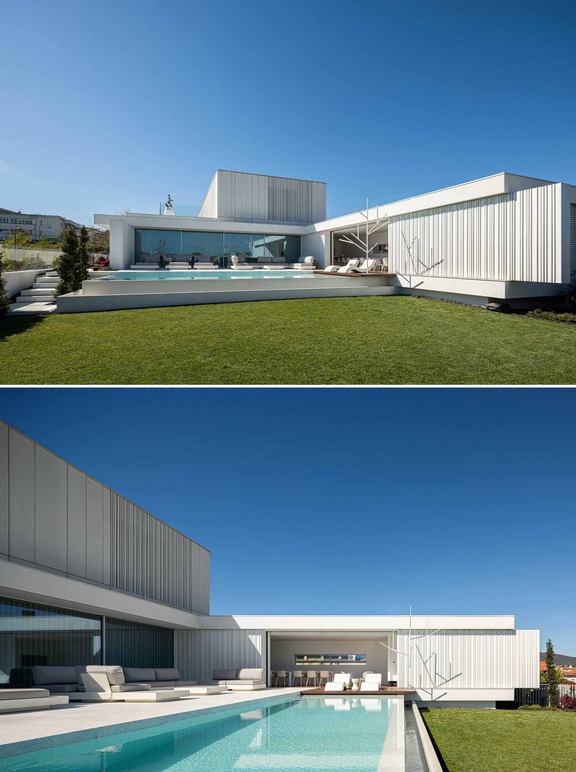 The rear of this modern home wraps around the pool and yard, and glass walls open the interior spaces to the outdoors for indoor/outdoor living.