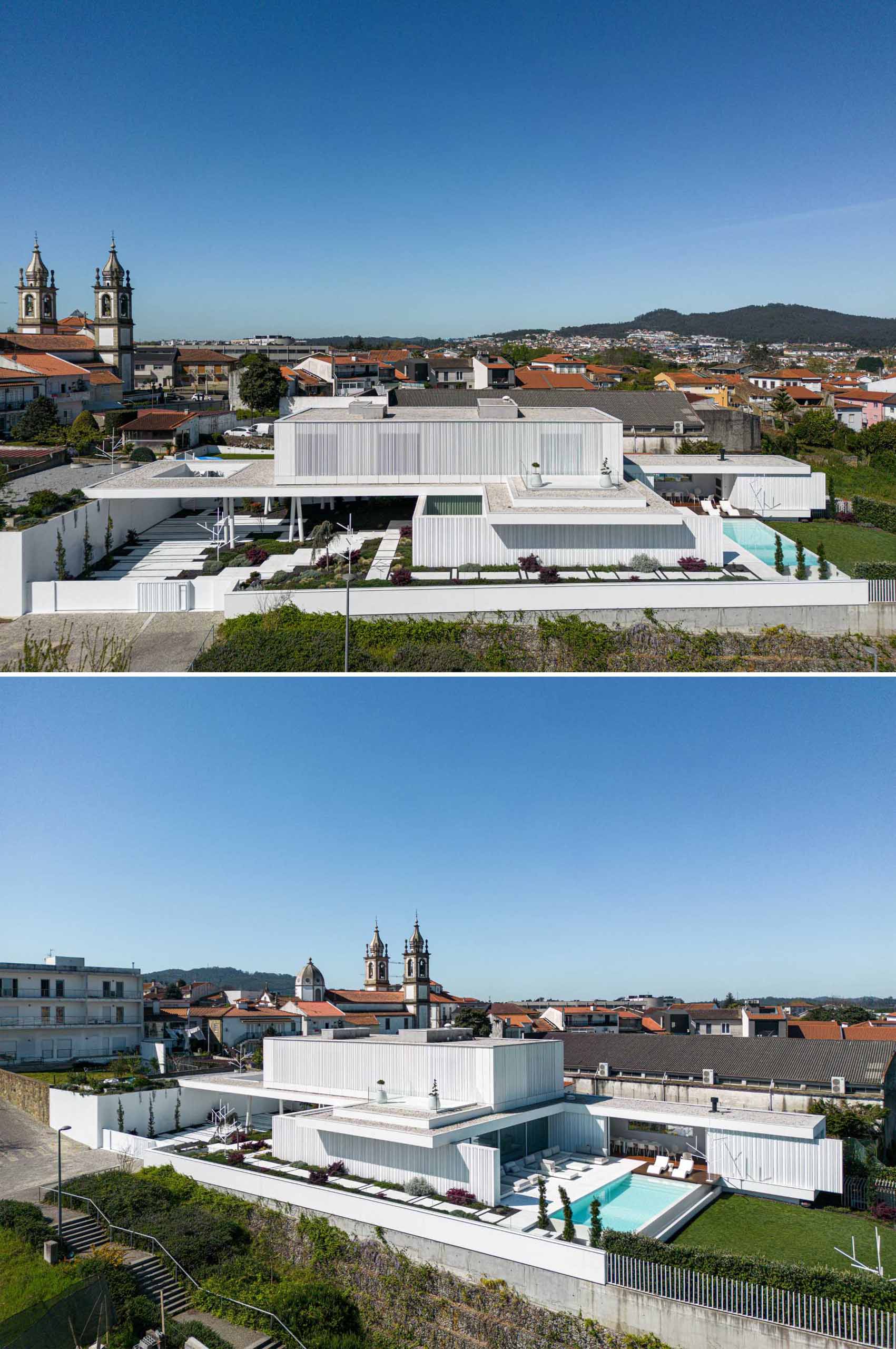 A modern home features an exterior of white concrete with textured accent walls, and a swimming pool with expansive patio.