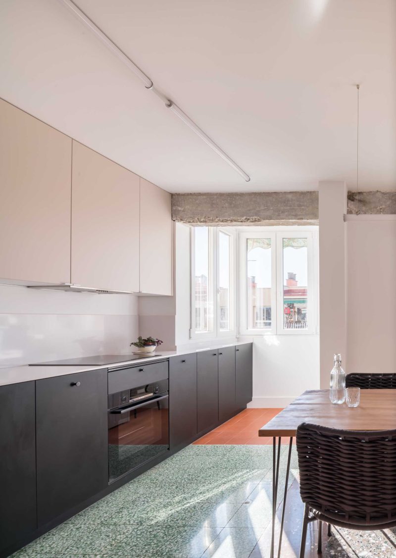 A brightly coloured shelving unit helps to define areas in this