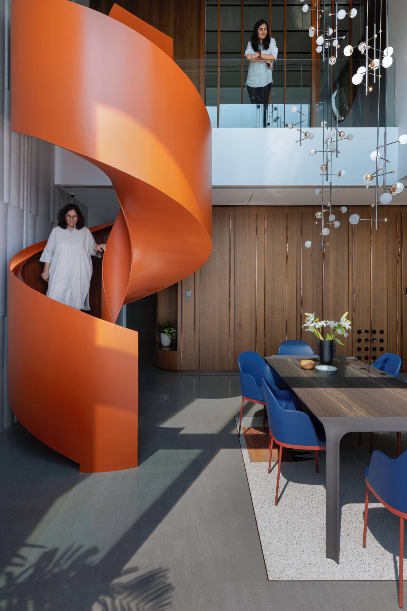 Image showcasing An Orange Spiral Staircase Is An Eye-Catching Feature Inside This Apartment