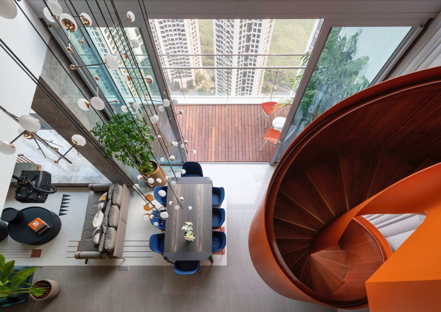View of An Orange Spiral Staircase Is An Eye-Catching Feature Inside This Apartment