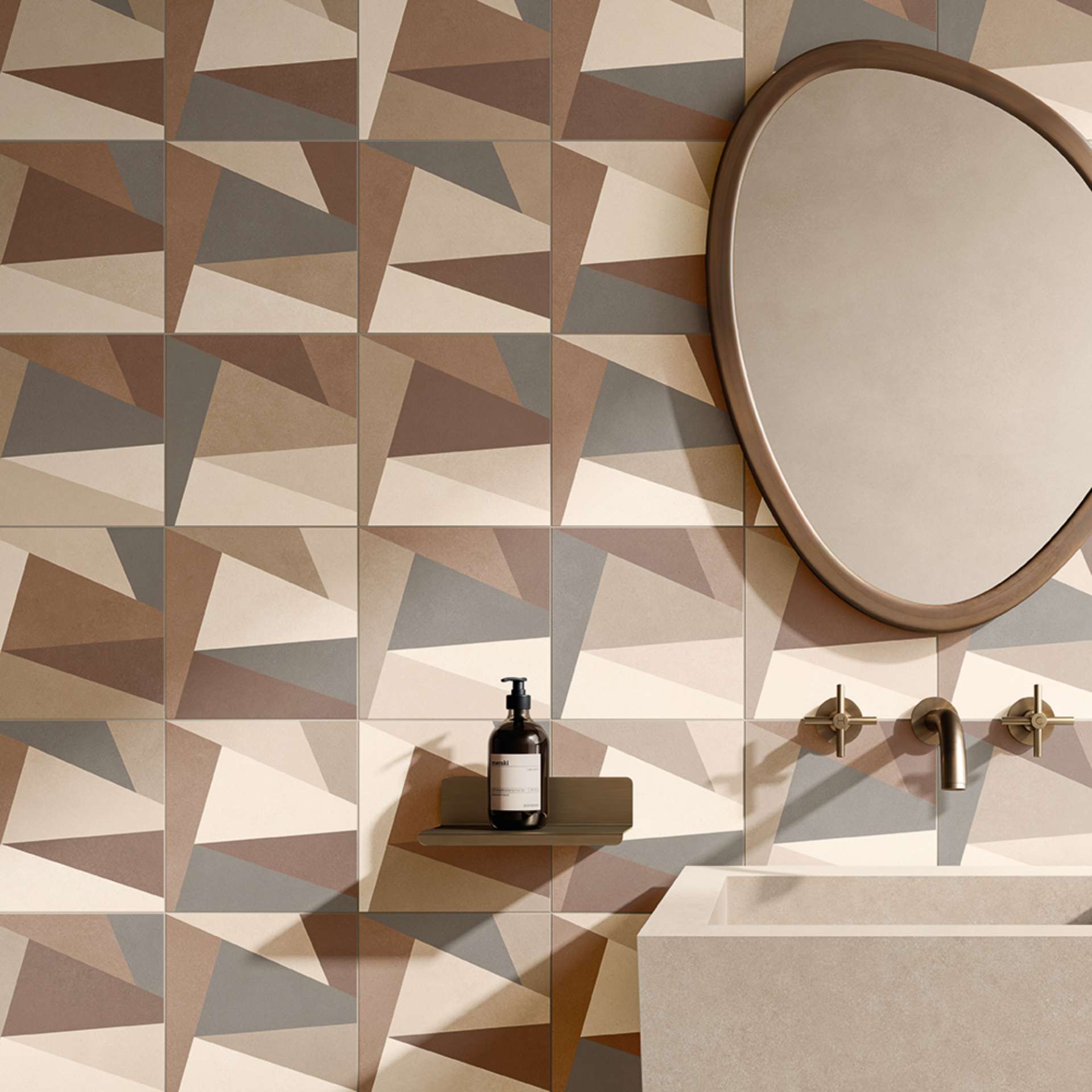 Bold, angular tiles bring sculptural drama to this neutral-toned bathroom. The geometric pattern plays with light and shadow, creating a dynamic backdrop for minimalist fixtures and a softly curved mirror. A confident choice for elevating everyday rituals.