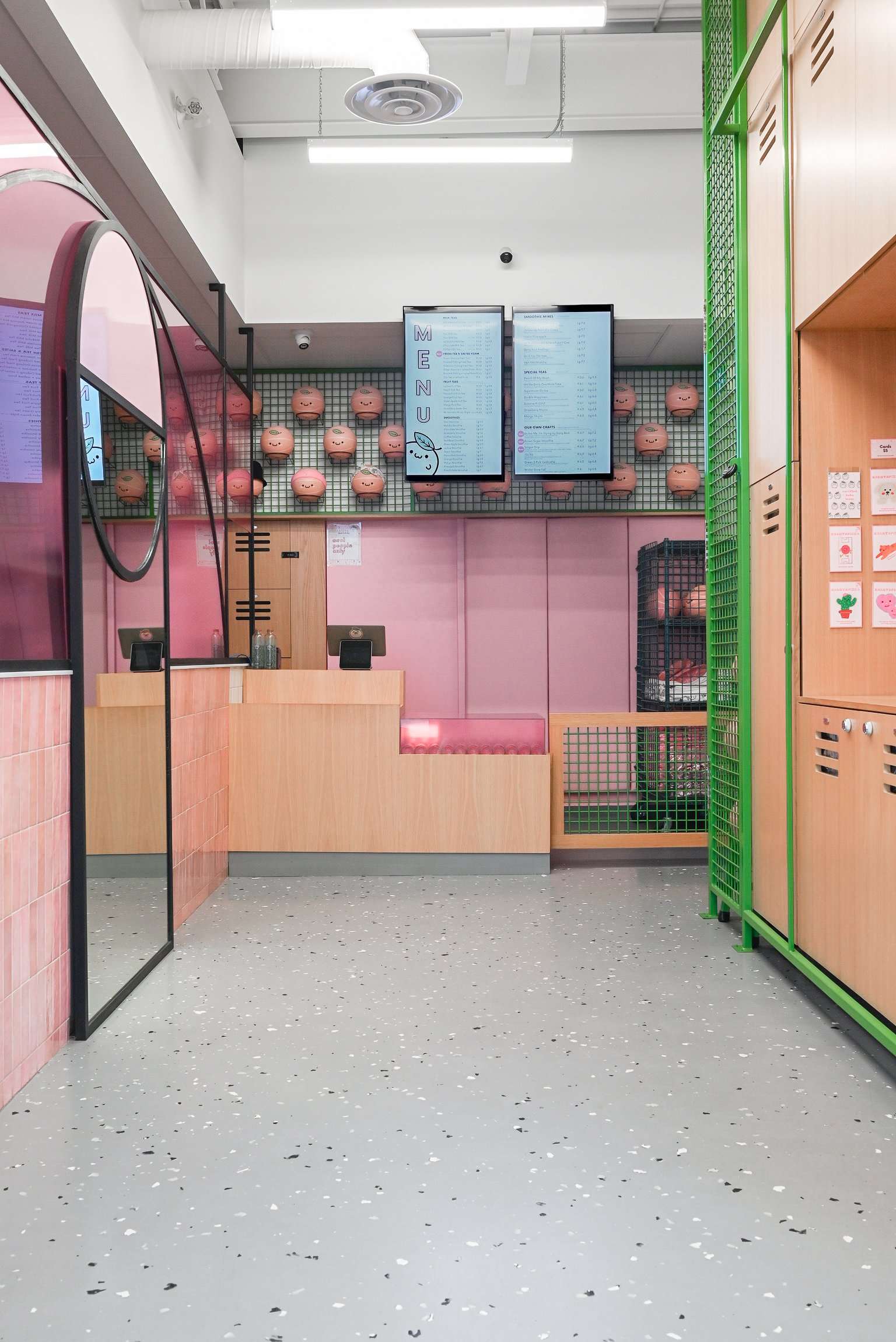 A playful wall of pastel basketballs and grid paneling brings unexpected charm to this bubble tea shop, while bright green lockers and wood finishes echo a sporty locker room vibe. A fun and functional twist on boba shop design that blends athletic energy with cute, curated details.