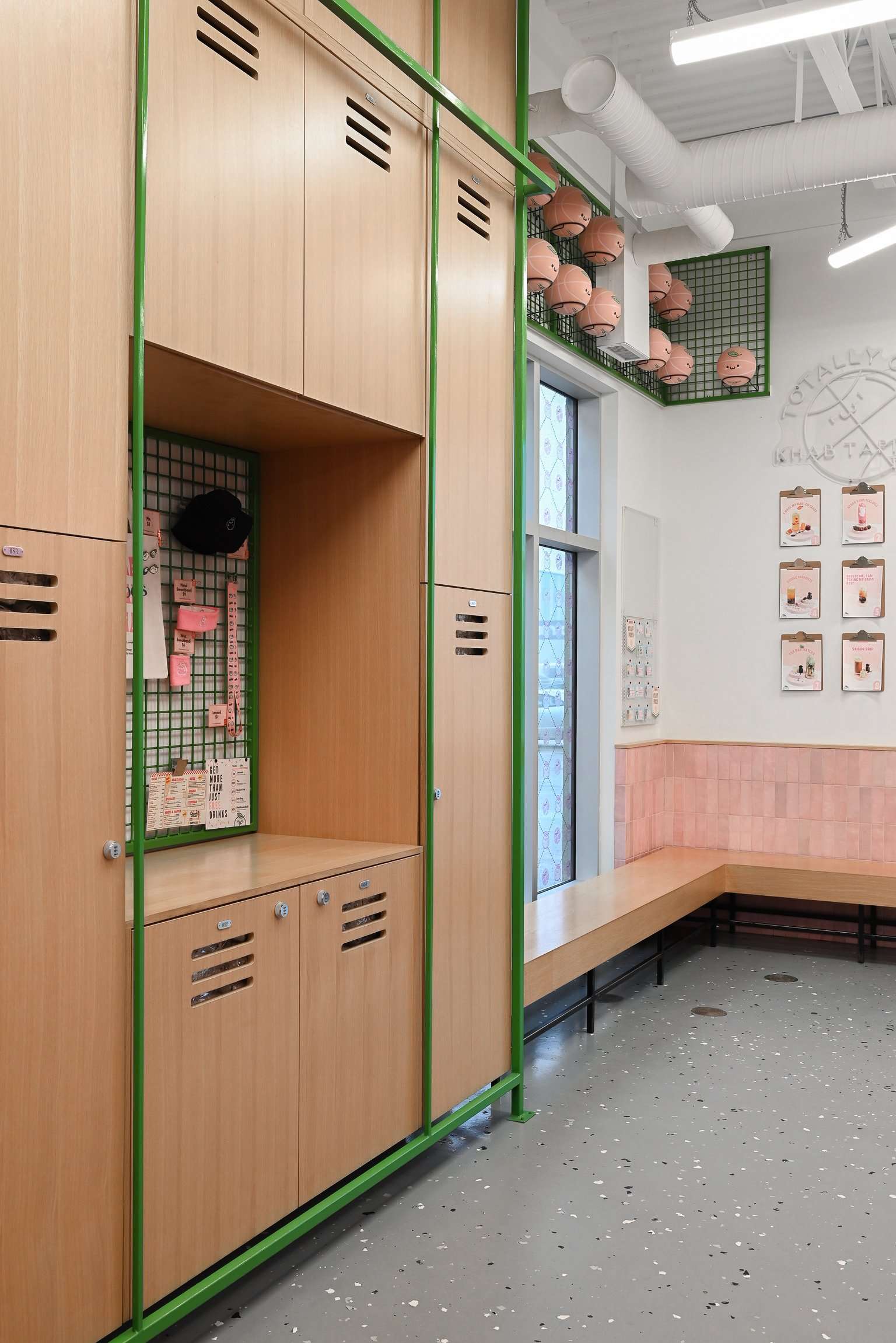 This clever locker-style wall brings a gym-inspired aesthetic to the bubble tea experience. With green accents, wood finishes and playful merch displays, it perfectly captures the fun-meets-functional vibe of this sporty, design-forward space.
