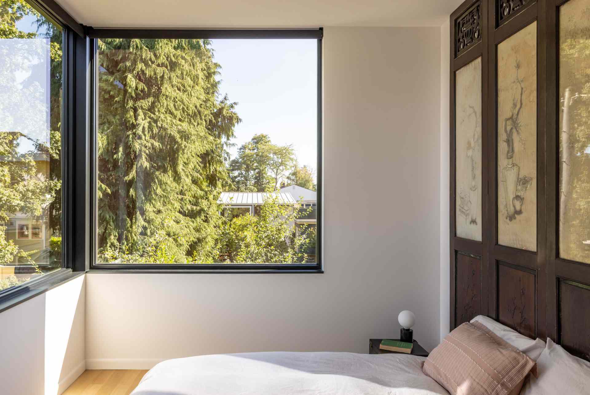 Modern bedroom with corner windows.