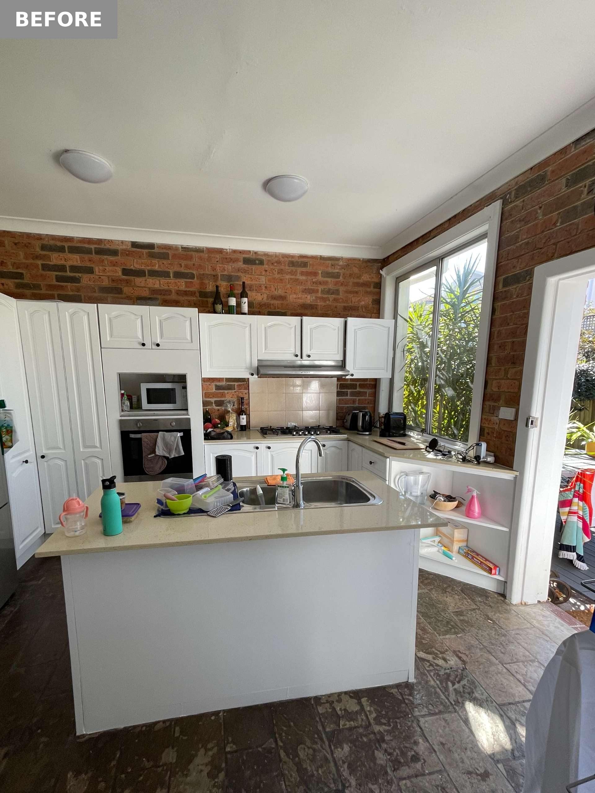 BEFORE - In the kitchen, which is at the rear of the home, clutter collected on the island, and corner shelving became a catch-all, highlighting the lack of purposeful storage.