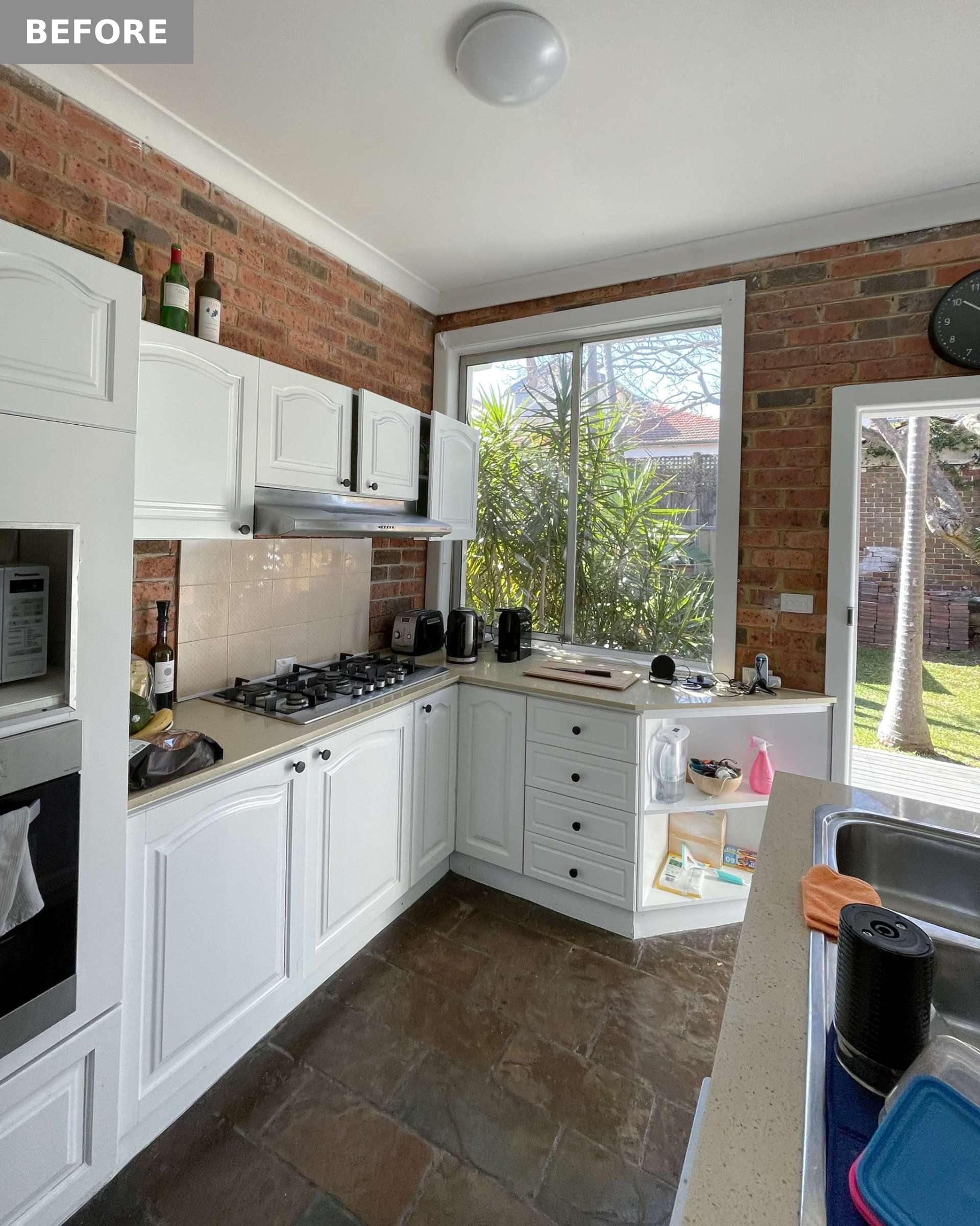 BEFORE - In the kitchen, which is at the rear of the home, clutter collected on the island, and corner shelving became a catch-all, highlighting the lack of purposeful storage.