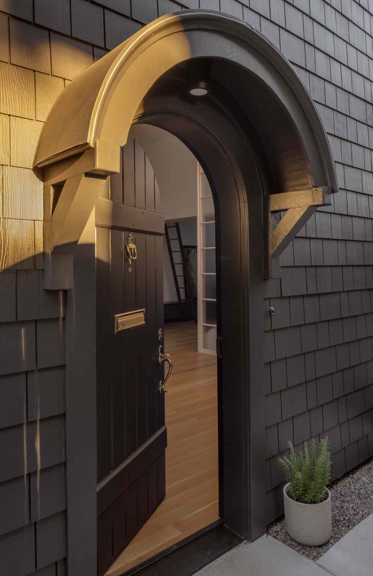 The round top front door at the side of the home has been given a fresh coat of black paint.