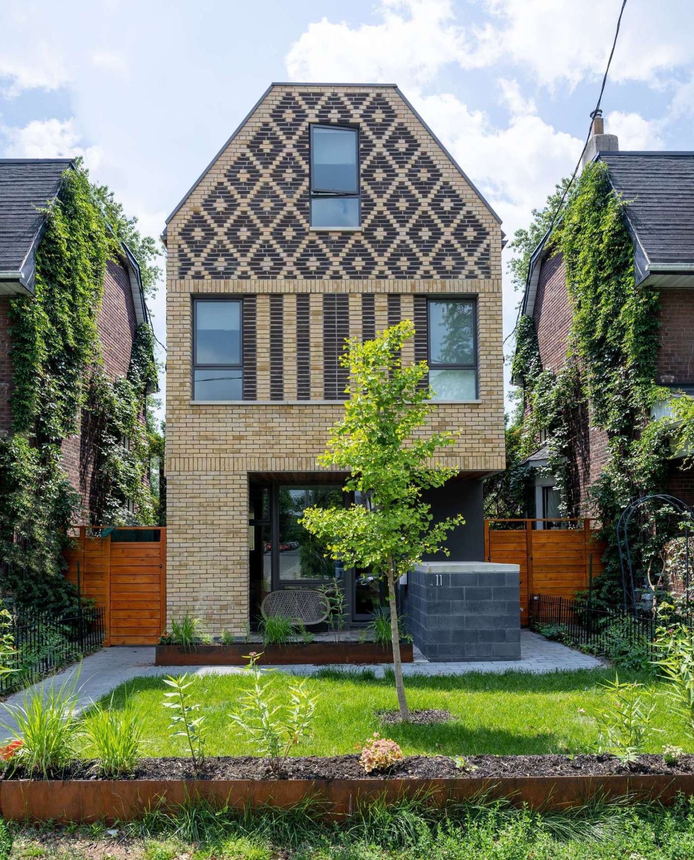 A contemporary home in Toronto, Canada, with diamond patterned brickwork on its facade.