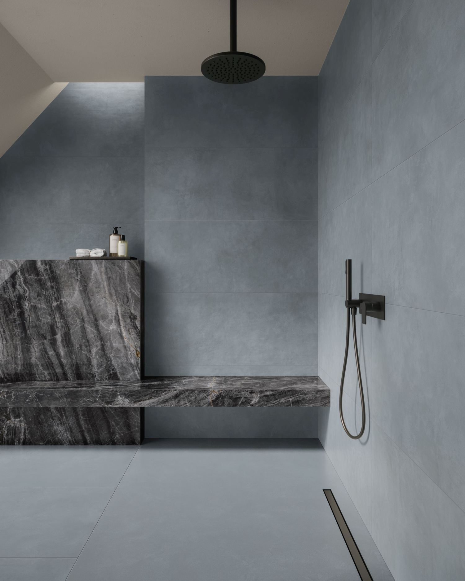 Minimalist and moody, this walk-in shower features smooth grey tiles and a striking stone bench that adds texture and drama. The matte black fixtures complete the clean, architectural look with effortless sophistication.