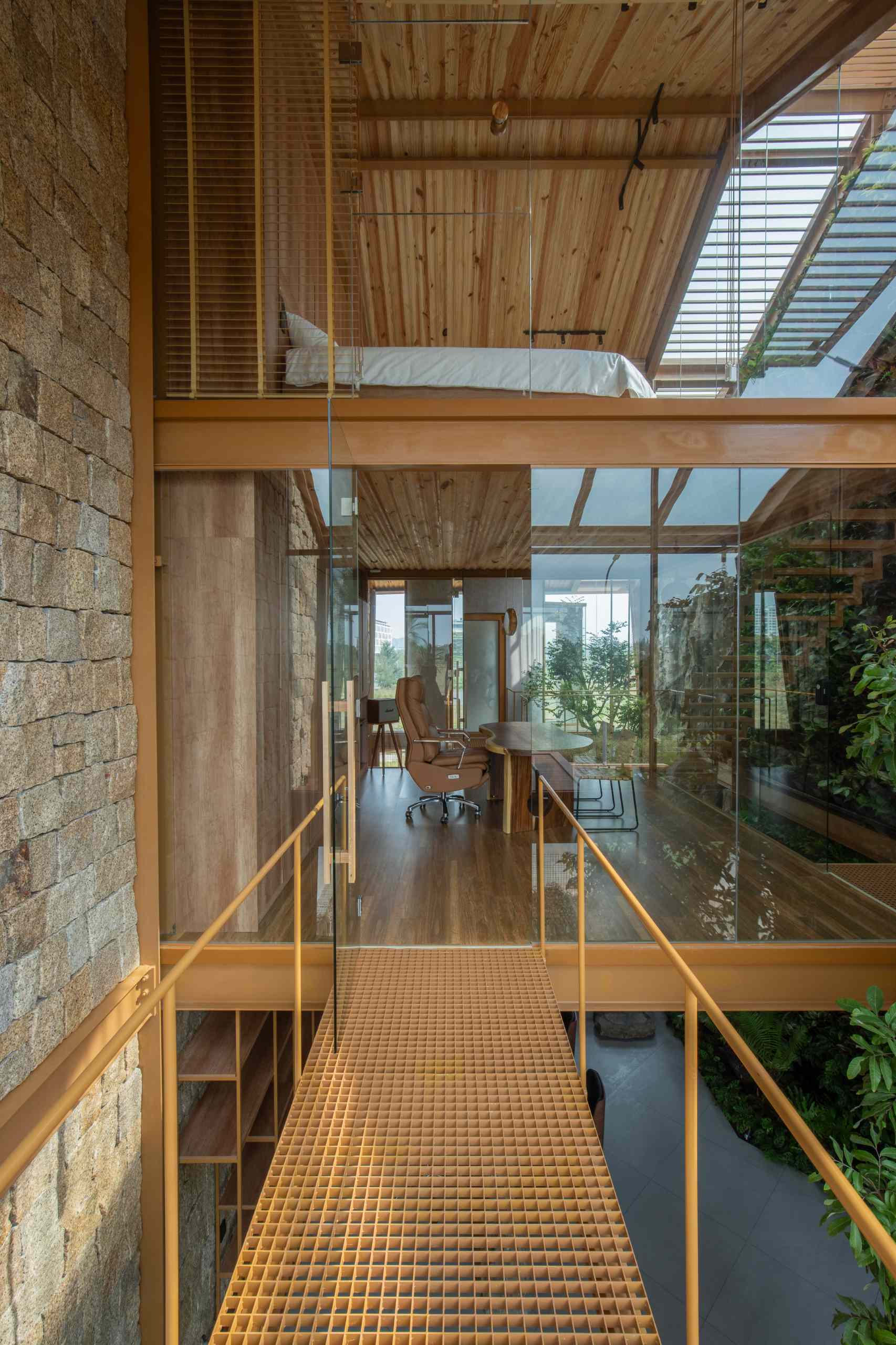 Suspended walkways framed in glass and steel weave through the home, connecting spaces while adding a sense of lightness and openness to the interior.