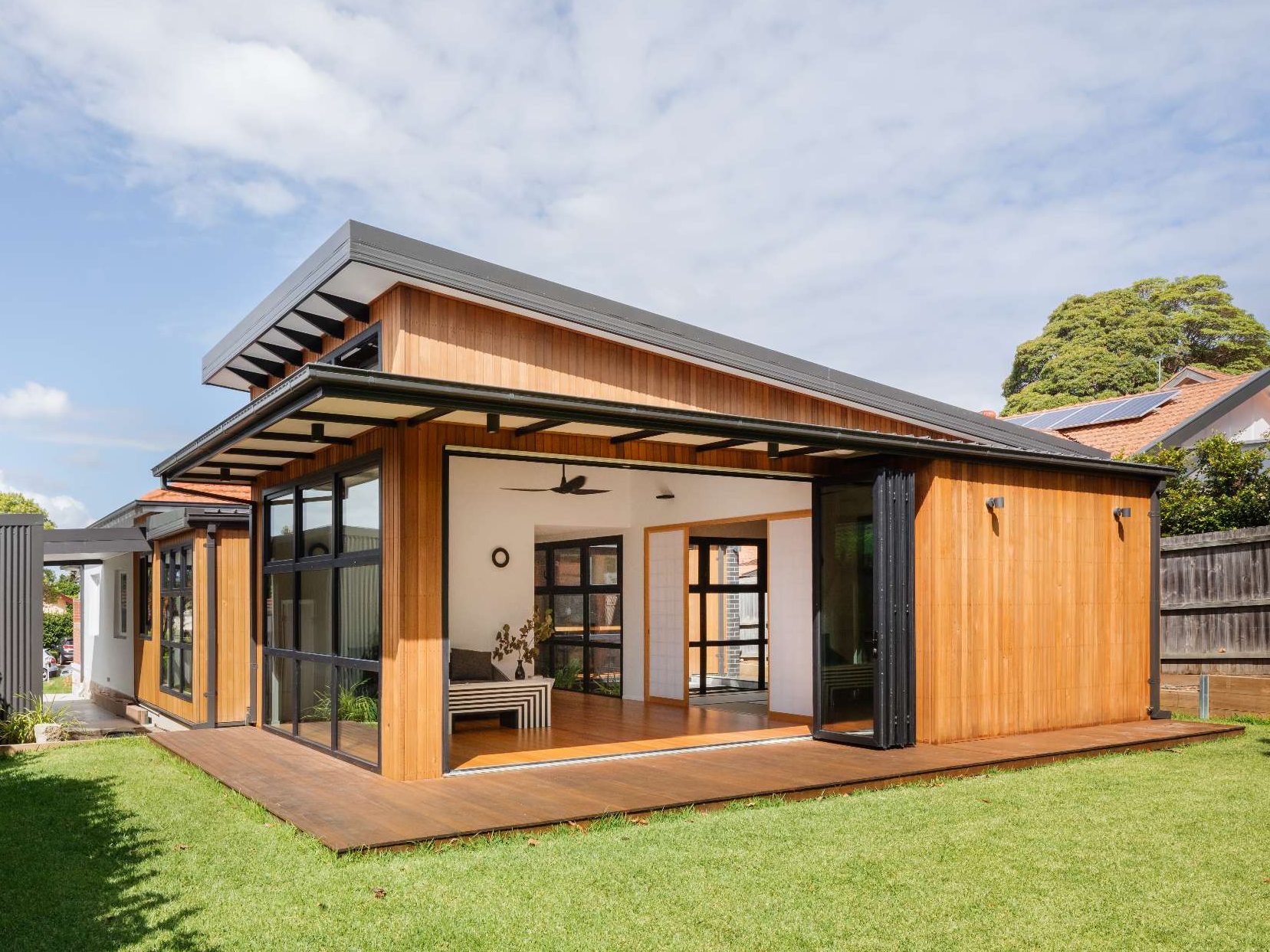 A low-lying timber extension opens directly to the garden, blending indoor comfort with outdoor ease in this Japanese-inspired Australian home.
