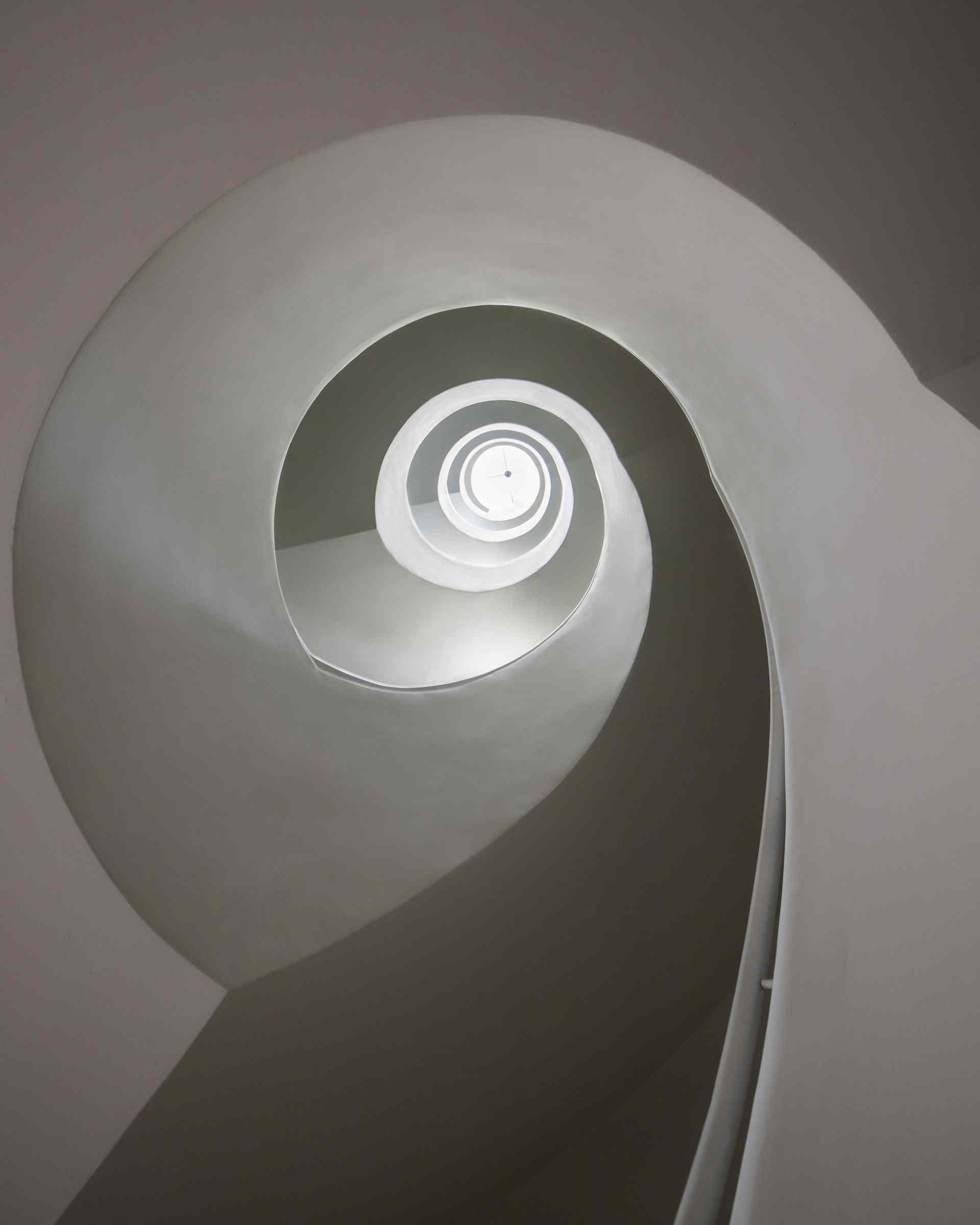 A modern apartment building has a central staircase.