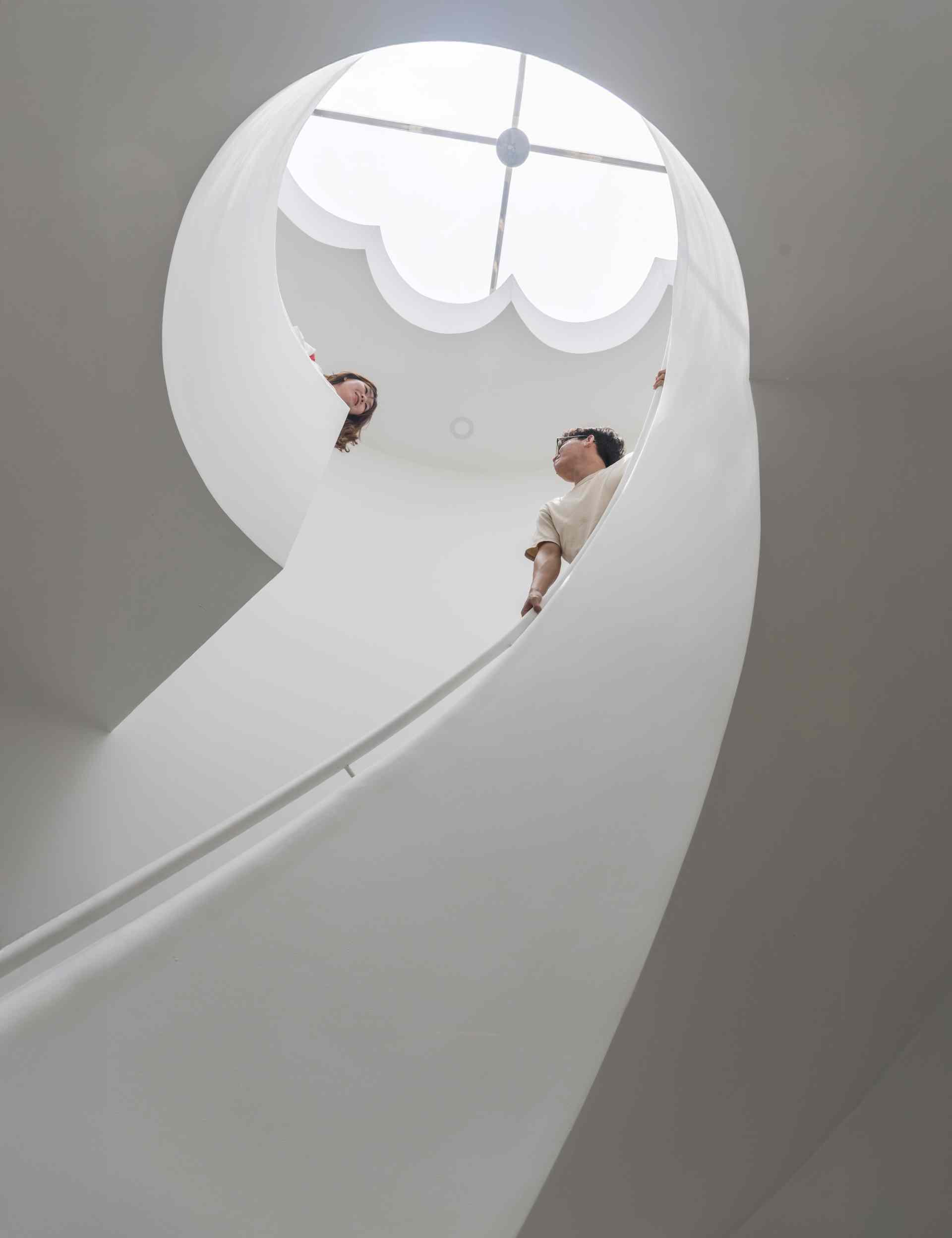 A modern apartment building has a central staircase.