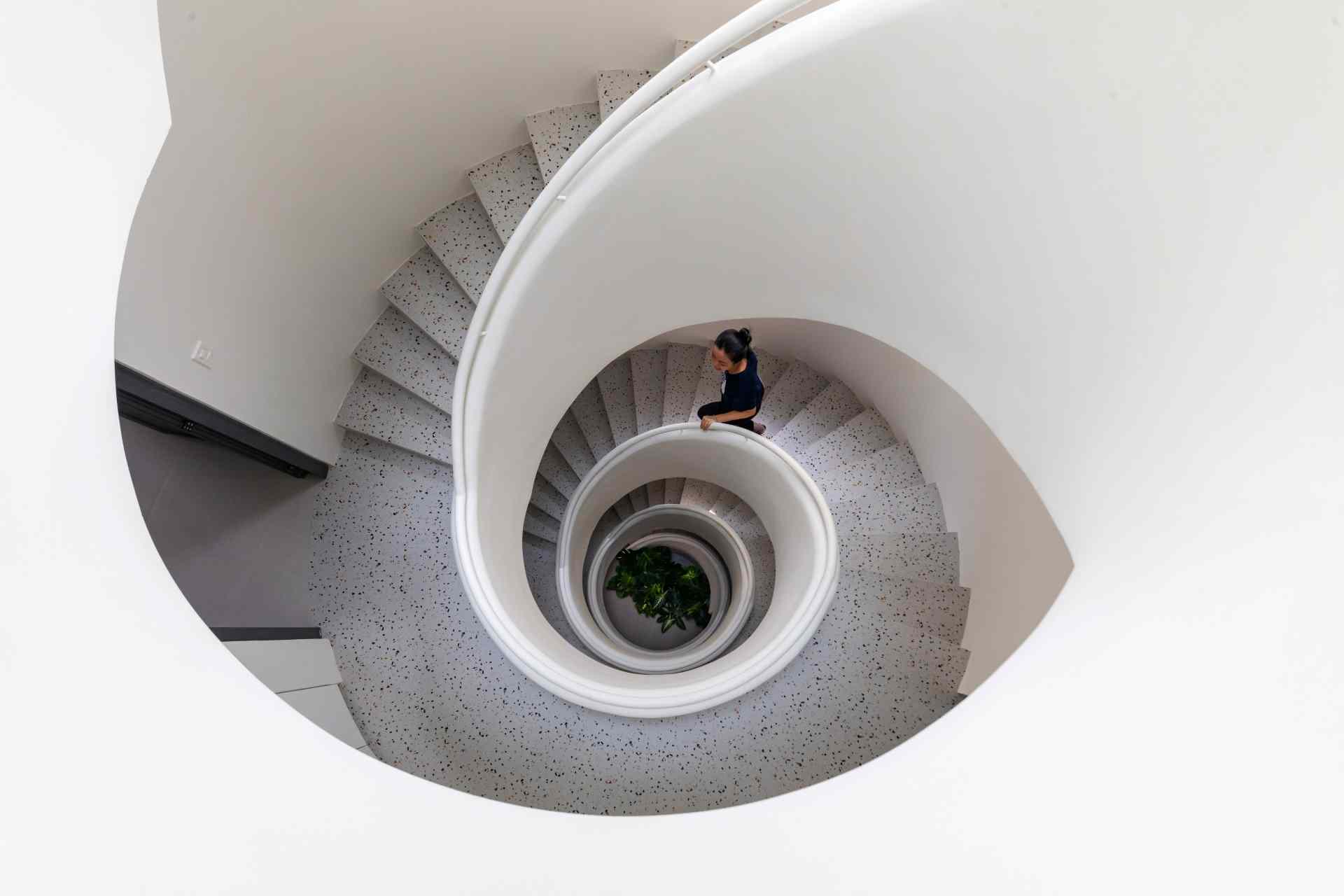 A modern apartment building has a central staircase.