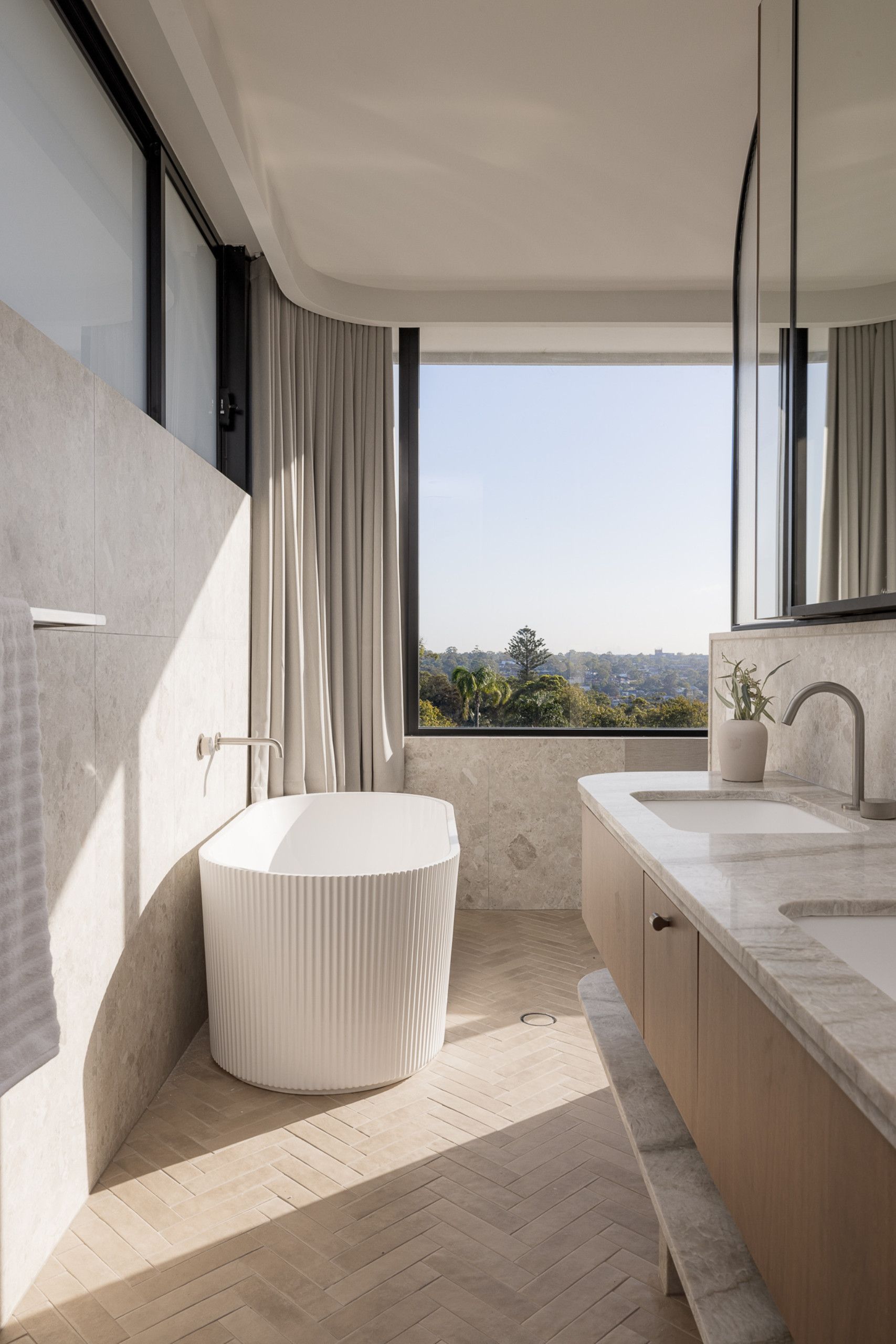 Modern ensuite bathroom with large window.