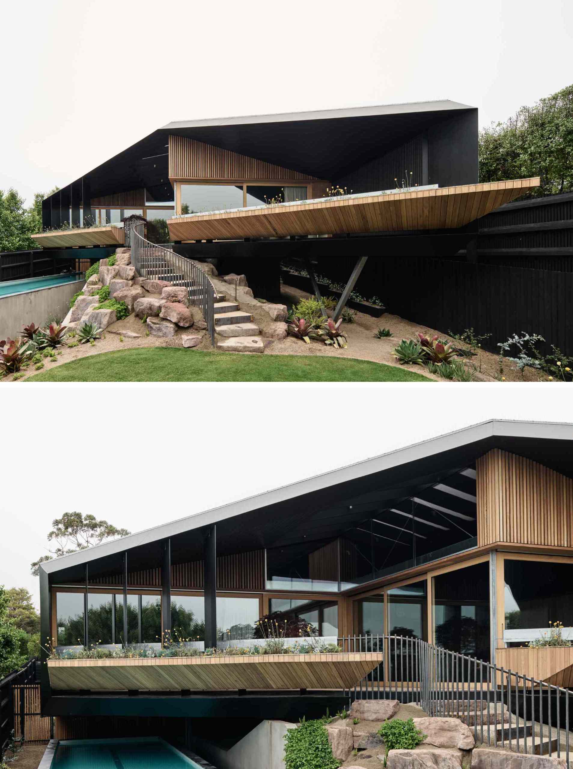 The rear facade blends bold architecture with the natural landscape. An angular roof hovers over decks and planters, while a curving stairway winds through native plantings. Below, a sleek lap pool runs along the slope, grounding the structure in its coastal setting.