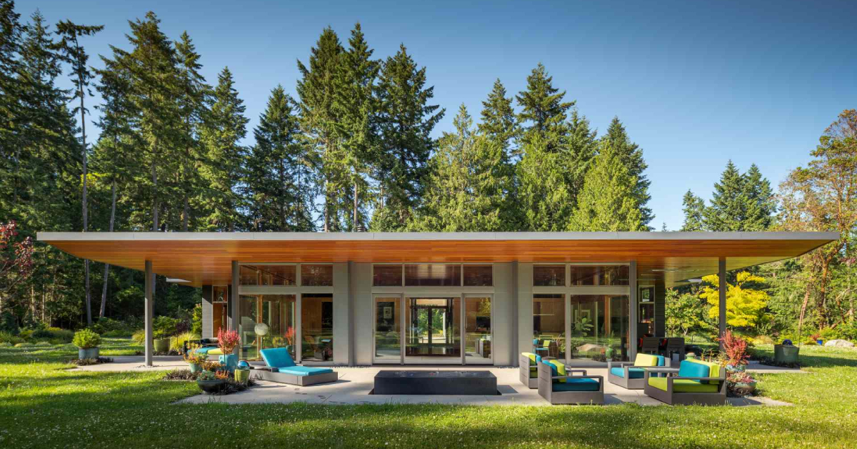 Modern meets nature in this home that opens to a meadow in the trees