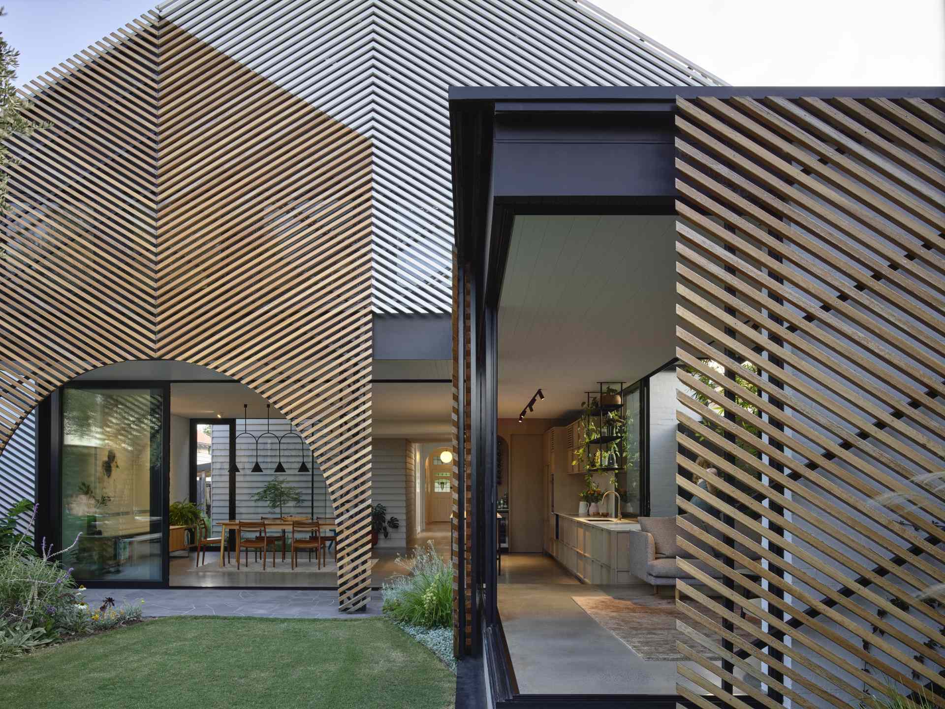 A batten screen was used to unify the rear extension with the original home, bringing together the addition in a simple meeting of forms, while providing shade and protection, restricting overlooking, and creating a covered verandah.