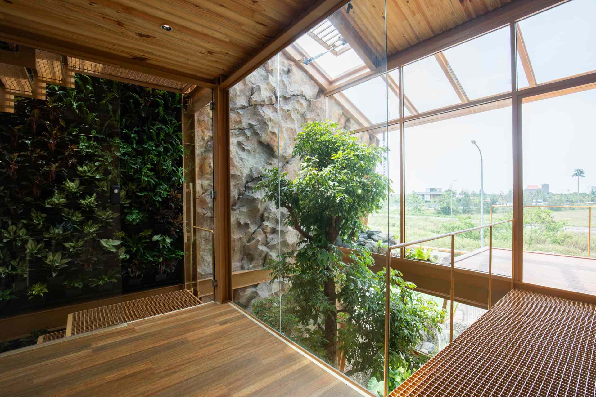 Trees rising from the ground floor are visible from every level of the home, creating a vertical connection to nature and a consistent visual anchor throughout the space.