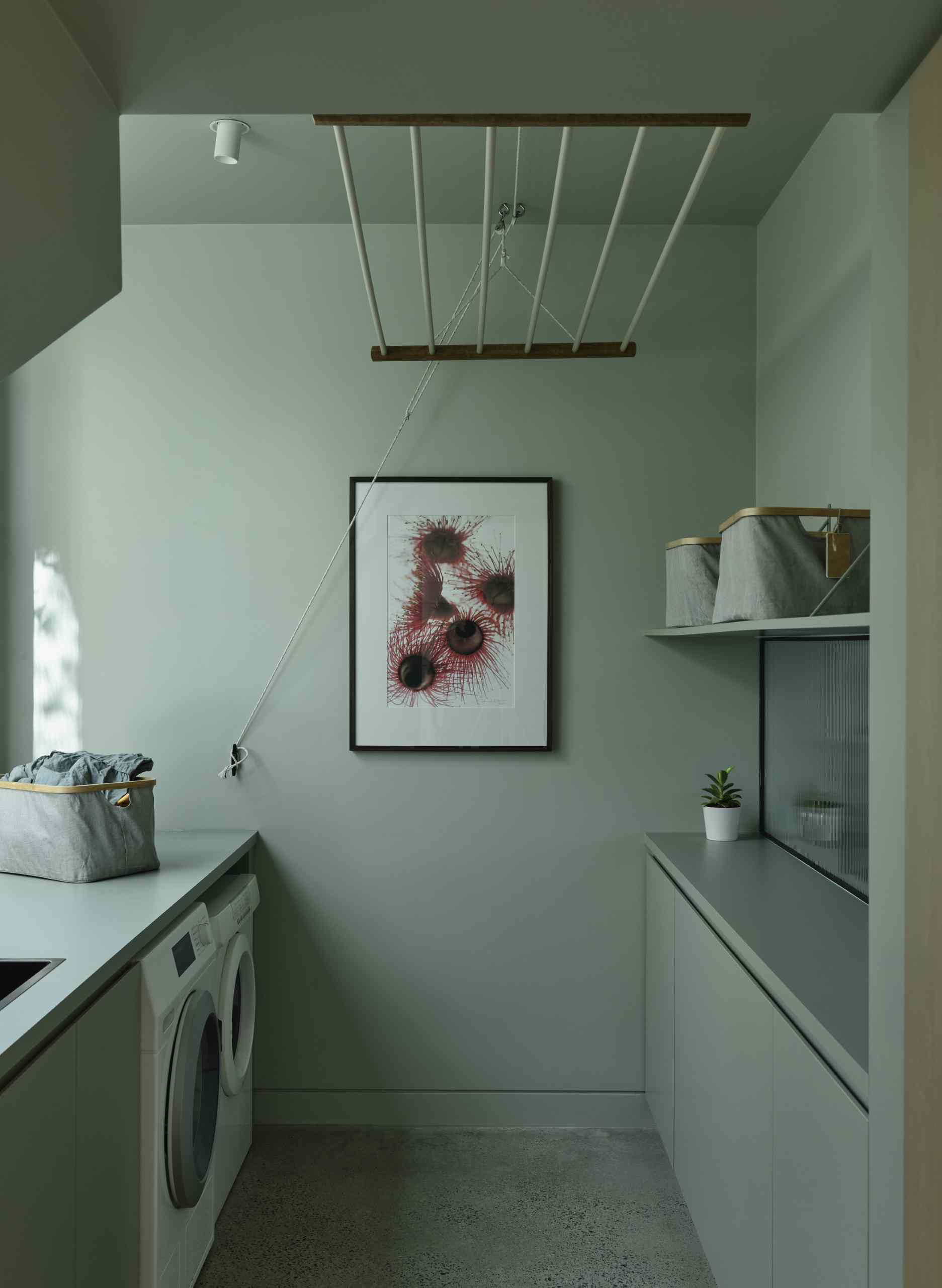 The laundry is tucked away in the hallway and features a window that provides natural light and views of a small garden.