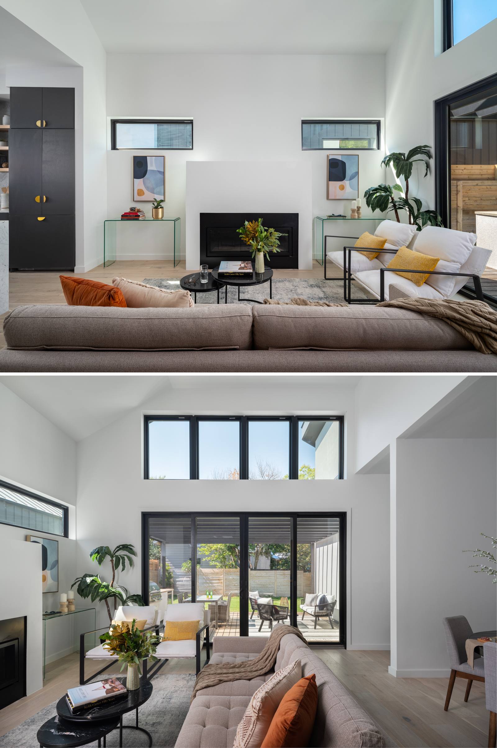 The living room feels open and light, with a vaulted ceiling and expansive windows that invite the outdoors in. A minimalist palette of crisp white walls, black-framed windows, and soft neutral furnishings is warmed by subtle accents throughout. A clean-lined fireplace grounds the space, while matching glass console tables and abstract artwork bring a sense of balance.