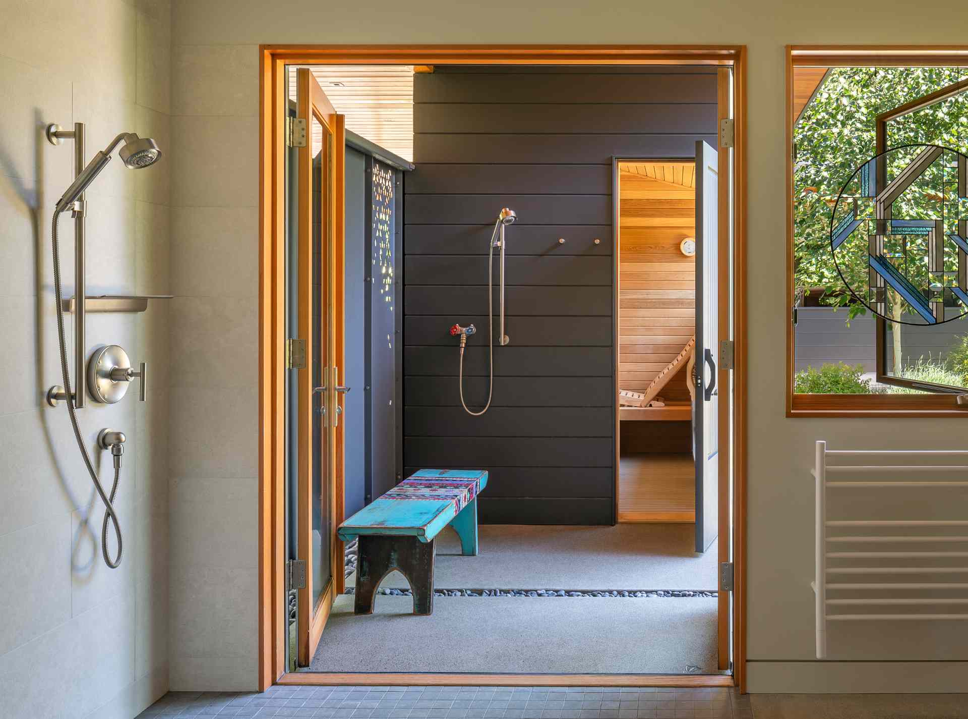 A modern home with both an interior and outdoor shower, as well as a sauna.