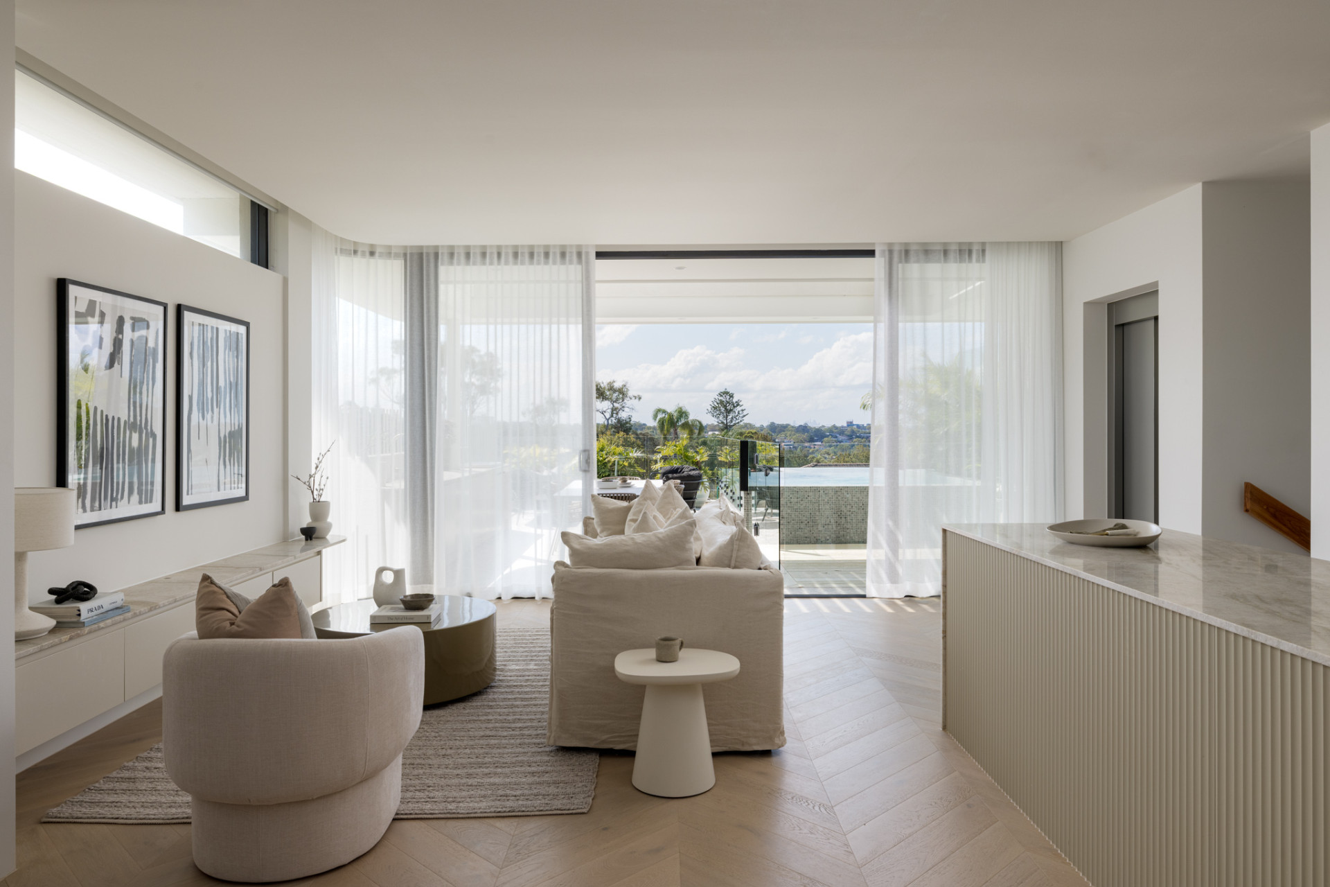 The interior of home is light and airy, with the materials providing warm and elegant tones with the use of oak floors, wool carpet, quartzite, and limestone.