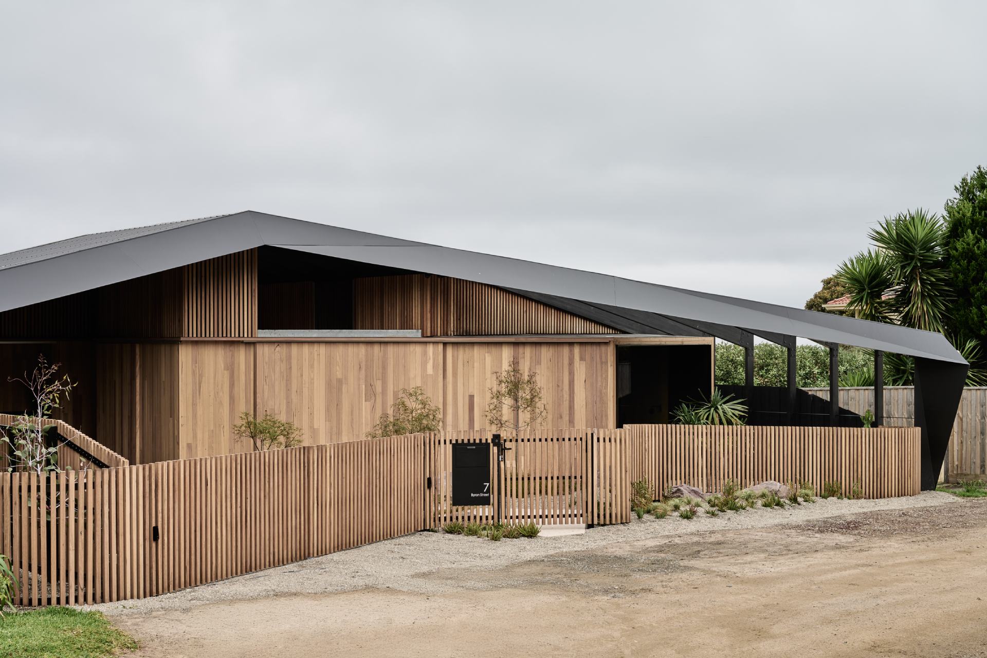 This striking facade balances bold geometry with natural warmth. Wrapped in Blackbutt shiplap cladding, the exterior feels soft and organic, while the dark Trimdeck Colorbond roof adds drama and definition with its sharp, clean lines.