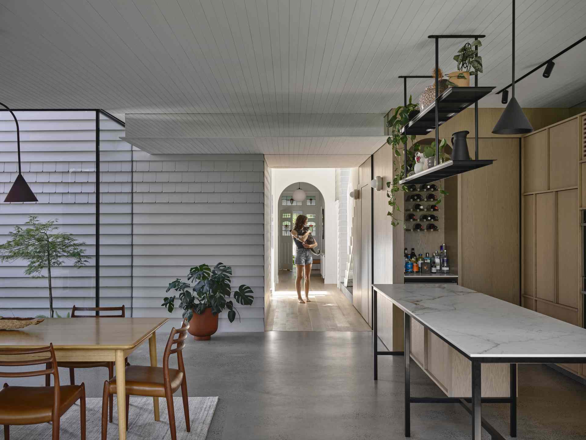 To define the original part of the house in respect to the addition, the external materiality of painted weatherboards is continued through internally.