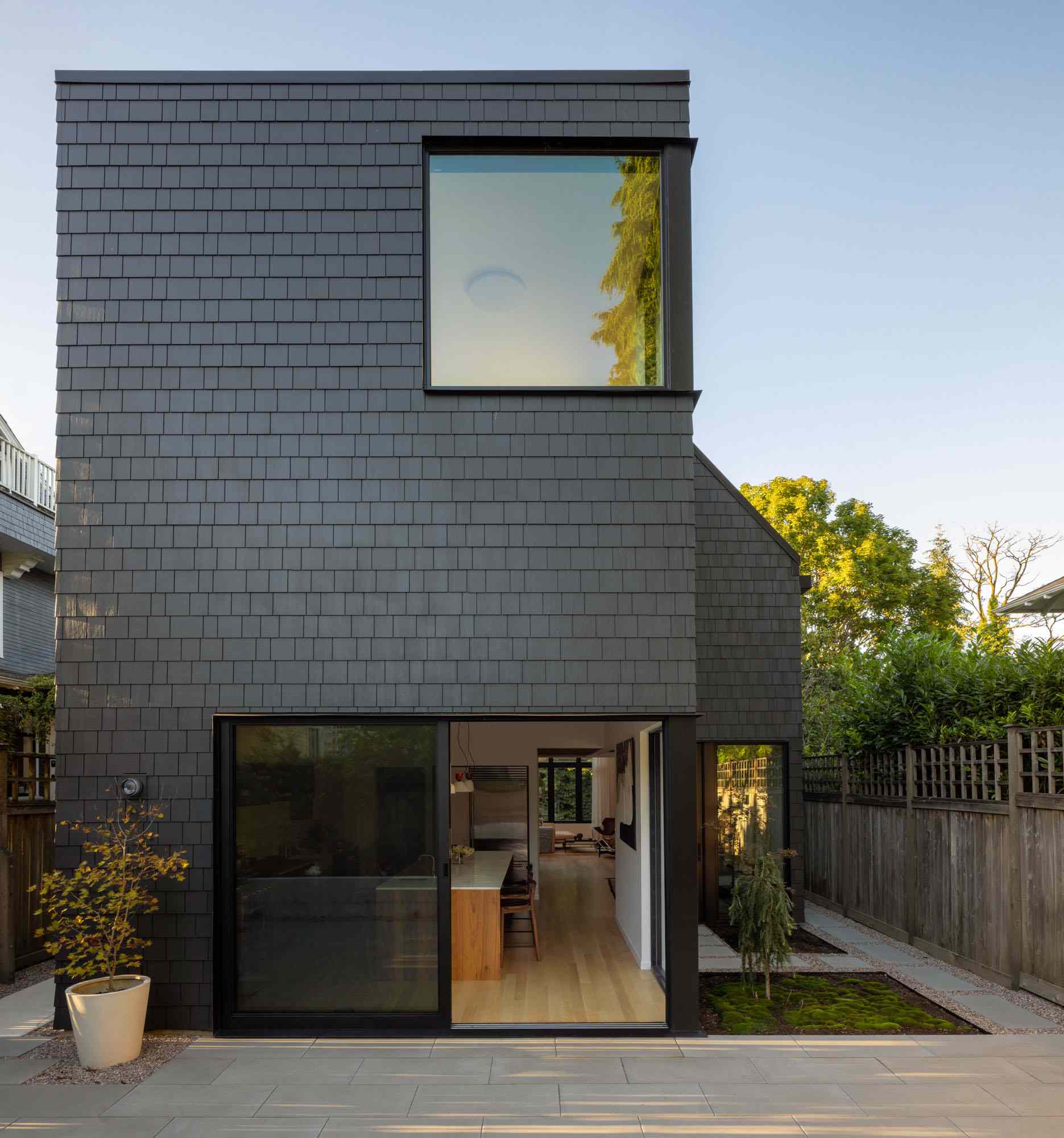 A contemporary home with a black shingle exterior.
