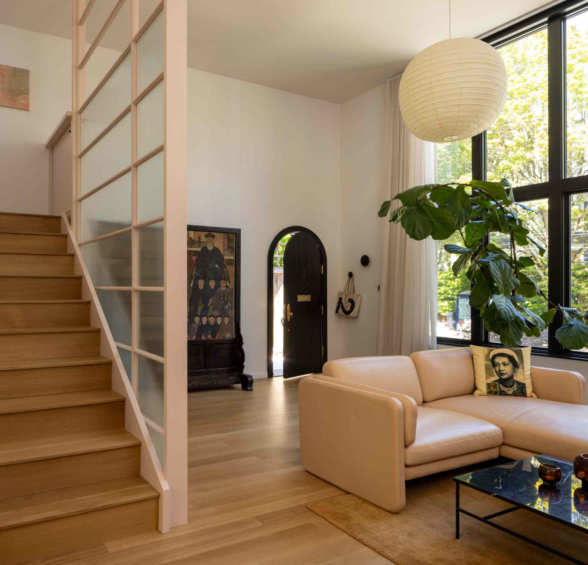 Inside, the original north studio window was enlarged to retain the same north light. The main level of the home now includes a living room, dining room, and kitchen.