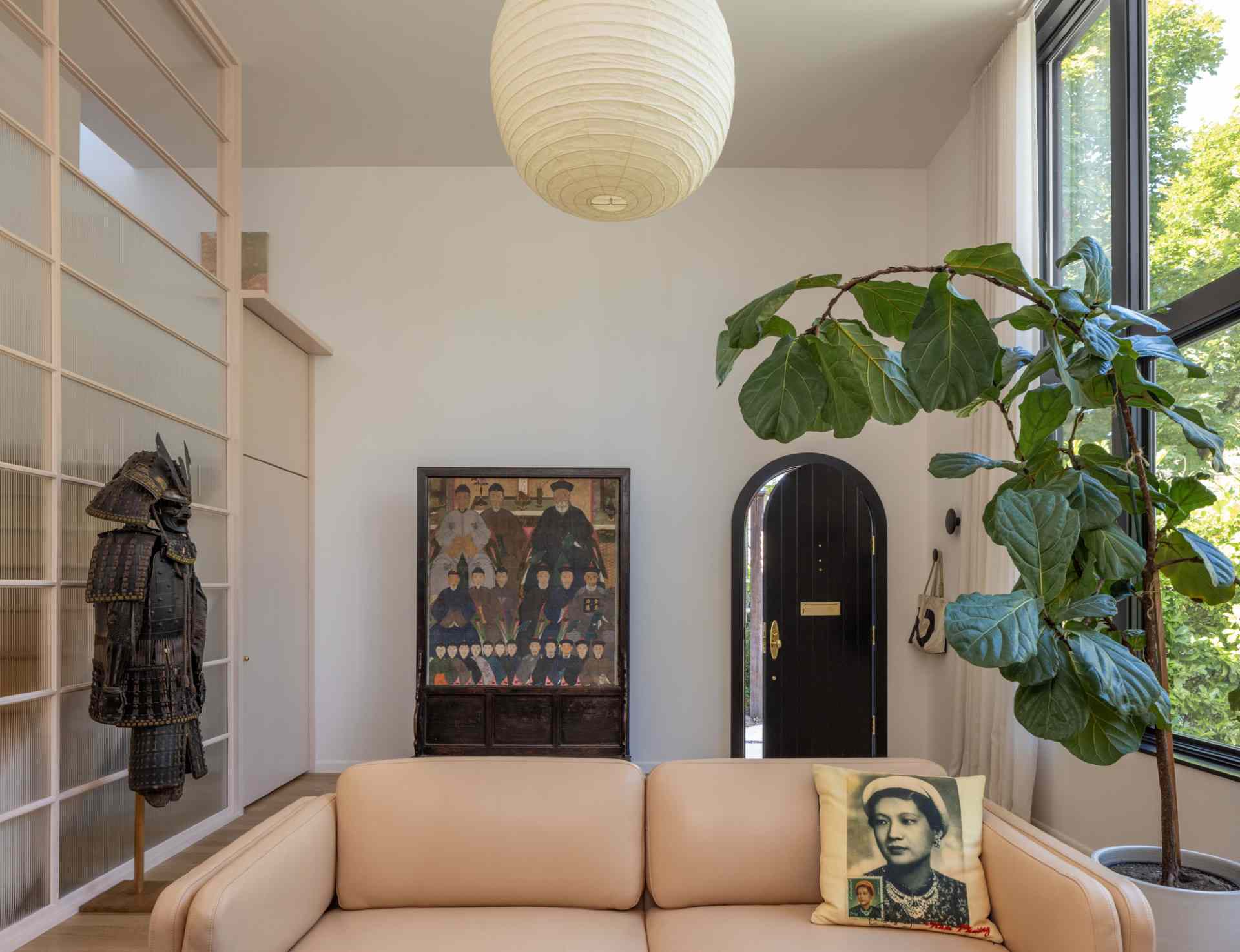Inside, the original north studio window was enlarged to retain the same north light. The main level of the home now includes a living room, dining room, and kitchen.