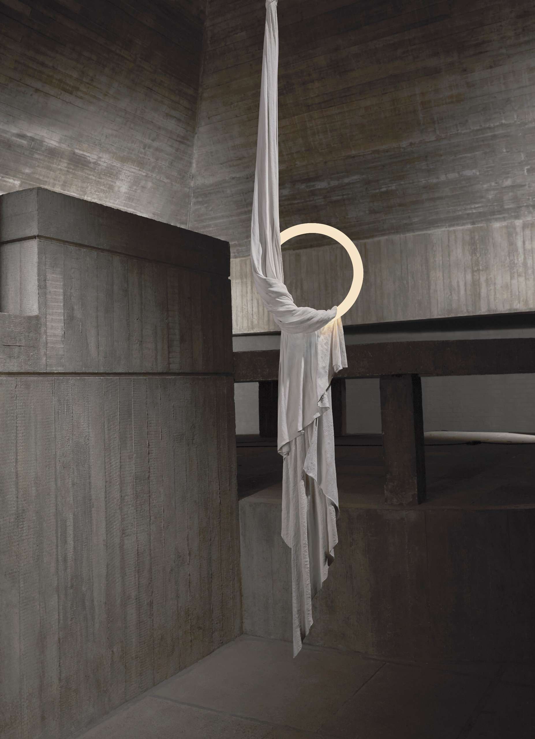 The Requiem Light Collection is handcrafted in plaster using a unique sculpting technique, capturing the fluidity of draped fabric in a striking form.
