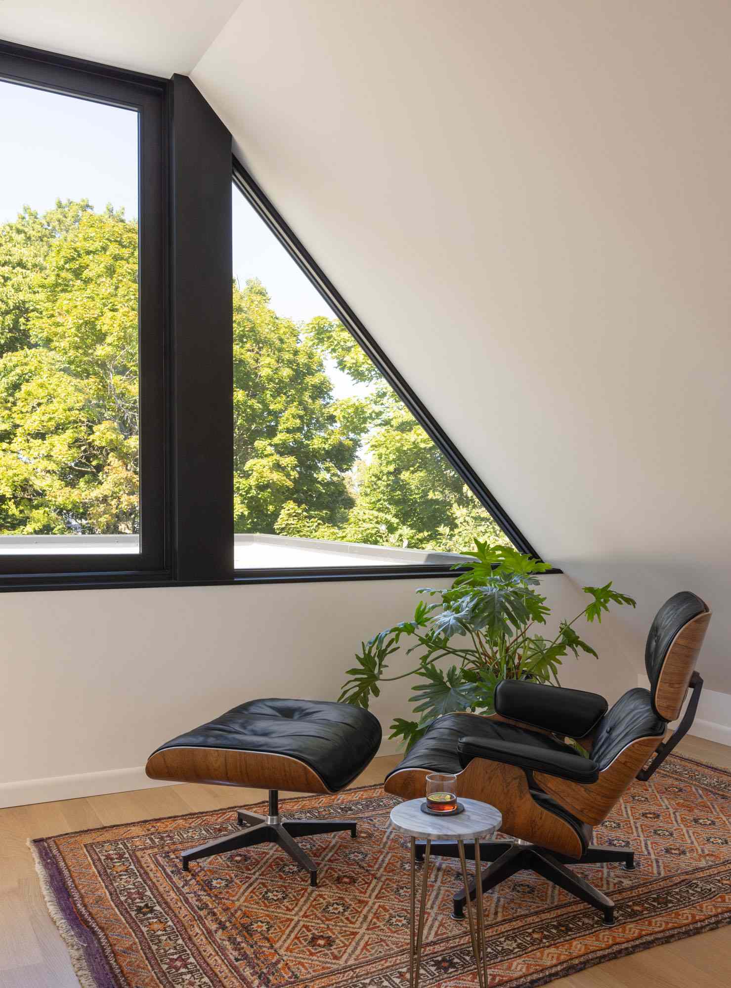 Contemporary seating area with triangle window.