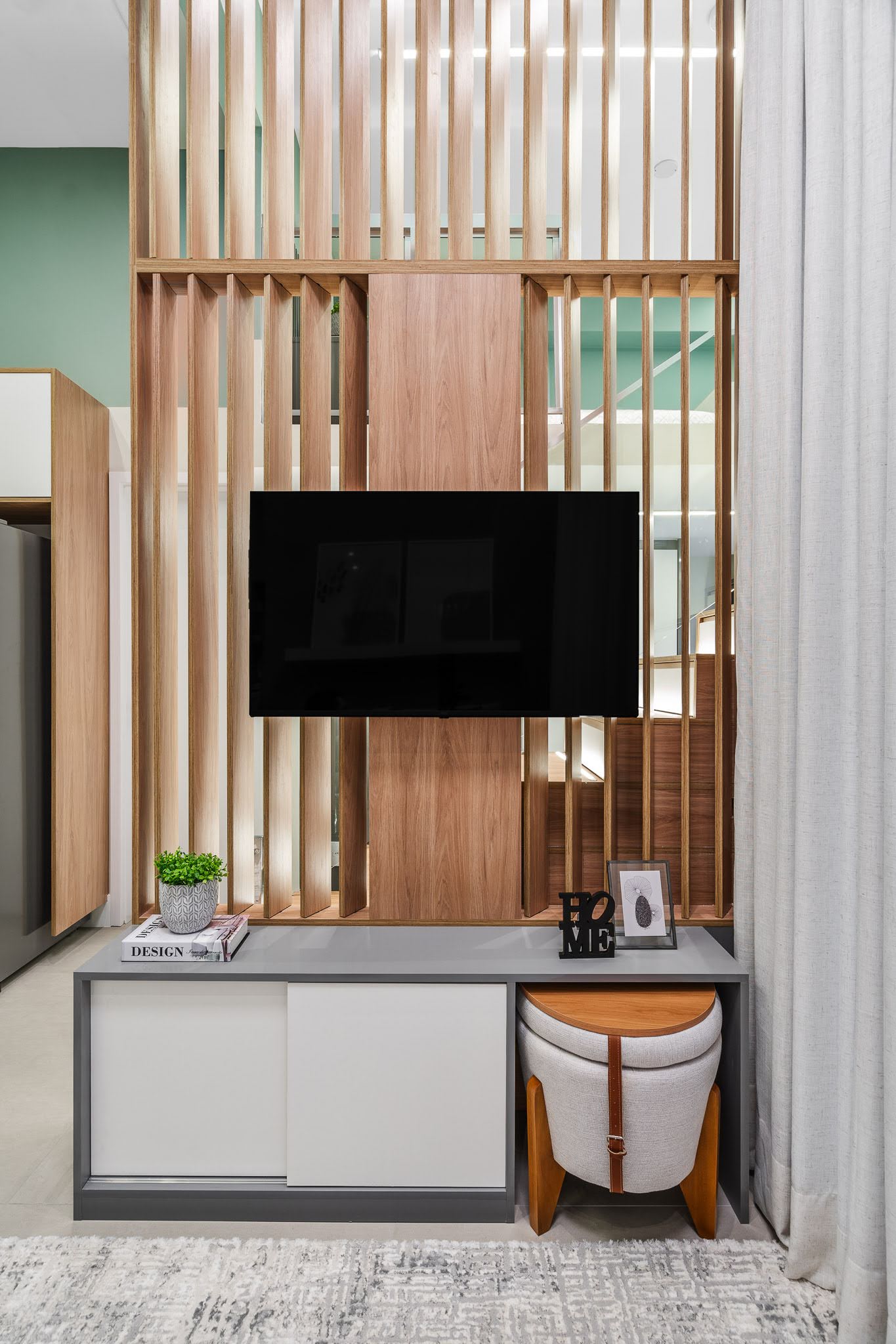 This divider between the stairs and living room, has moveable wood fins, allowing the light to be closed off when needed.