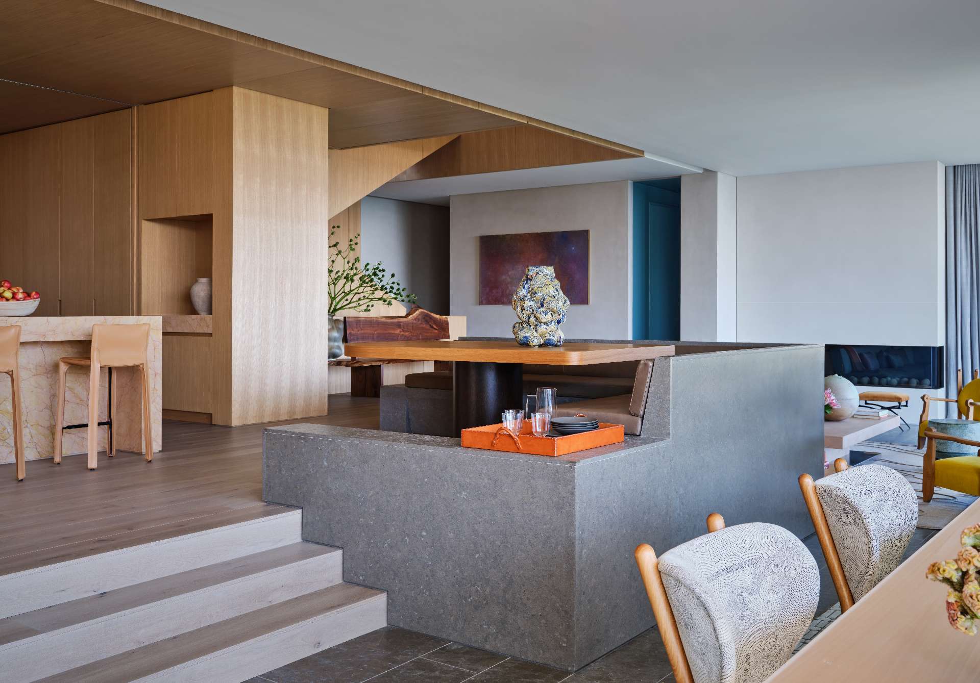 Tucked into corner of the open-plan living space, the breakfast nook with a built-in banquette creates an intimate dining zone.