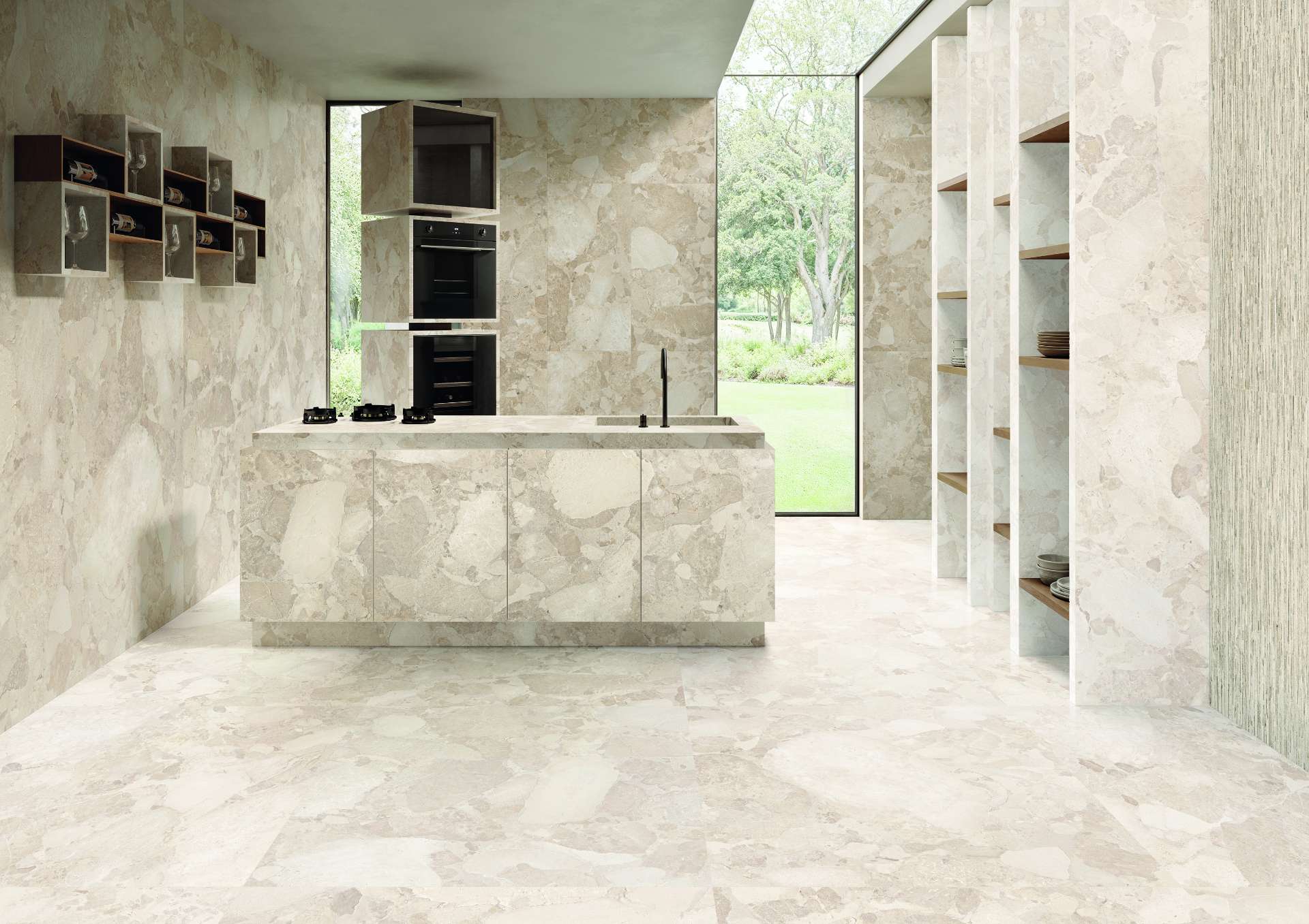 A seamless blend of terrazzo-inspired tiles wraps this sculptural kitchen in soft, natural patterning while floor-to-ceiling glazing connects the space to the lush green landscape just outside.