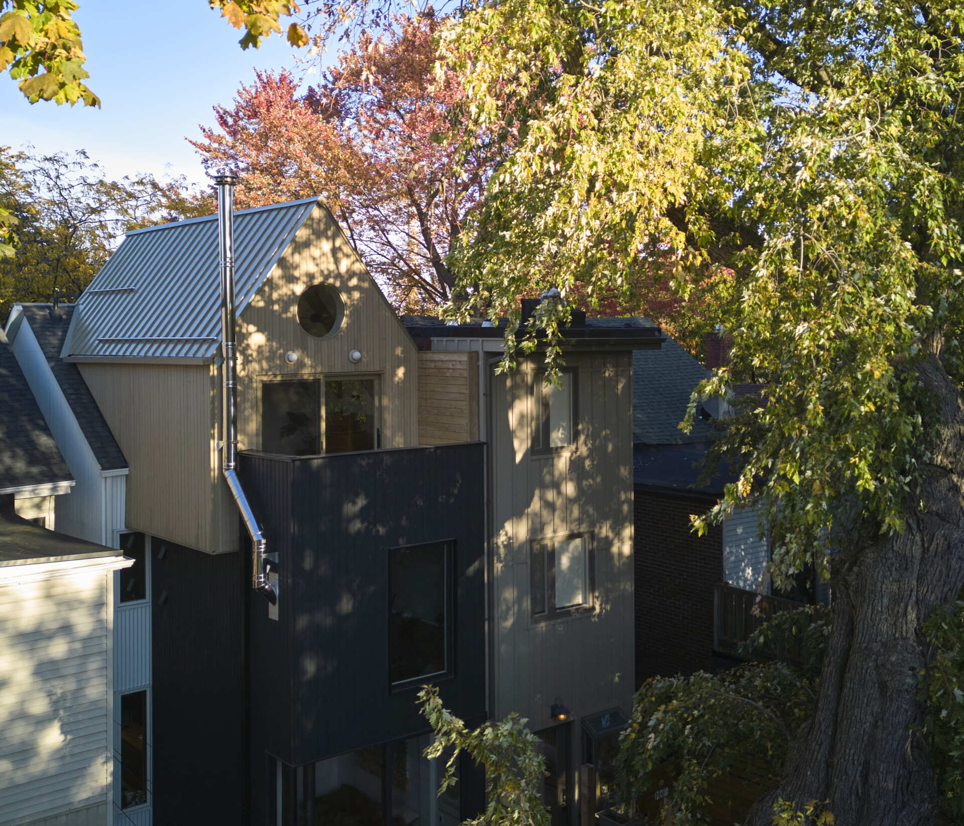 Discover a modern family home in Toronto that beautifully blends Victorian charm with a striking A-frame addition and warm natural materials.