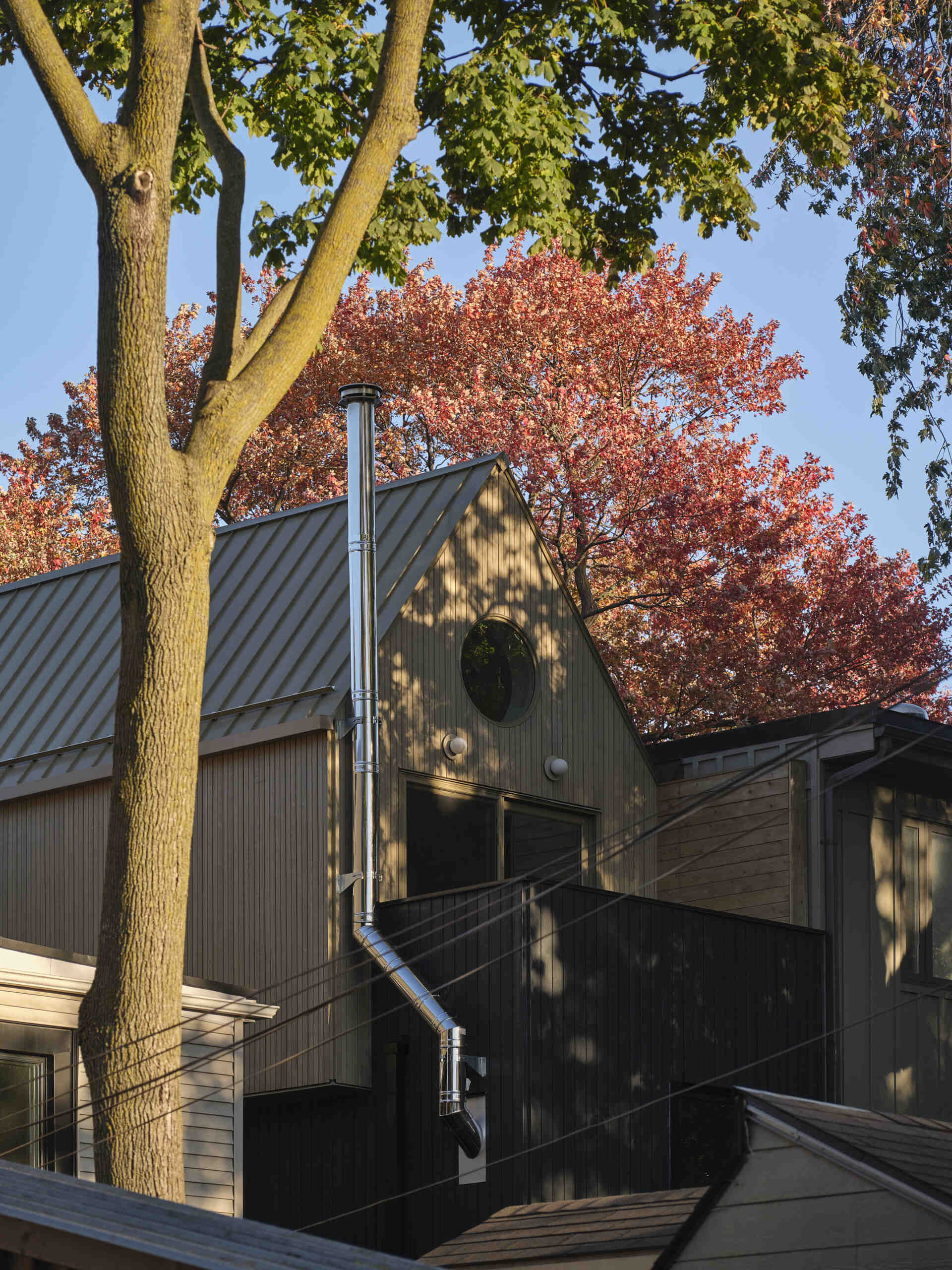 Discover a modern family home in Toronto that beautifully blends Victorian charm with a striking A-frame addition and warm natural materials.
