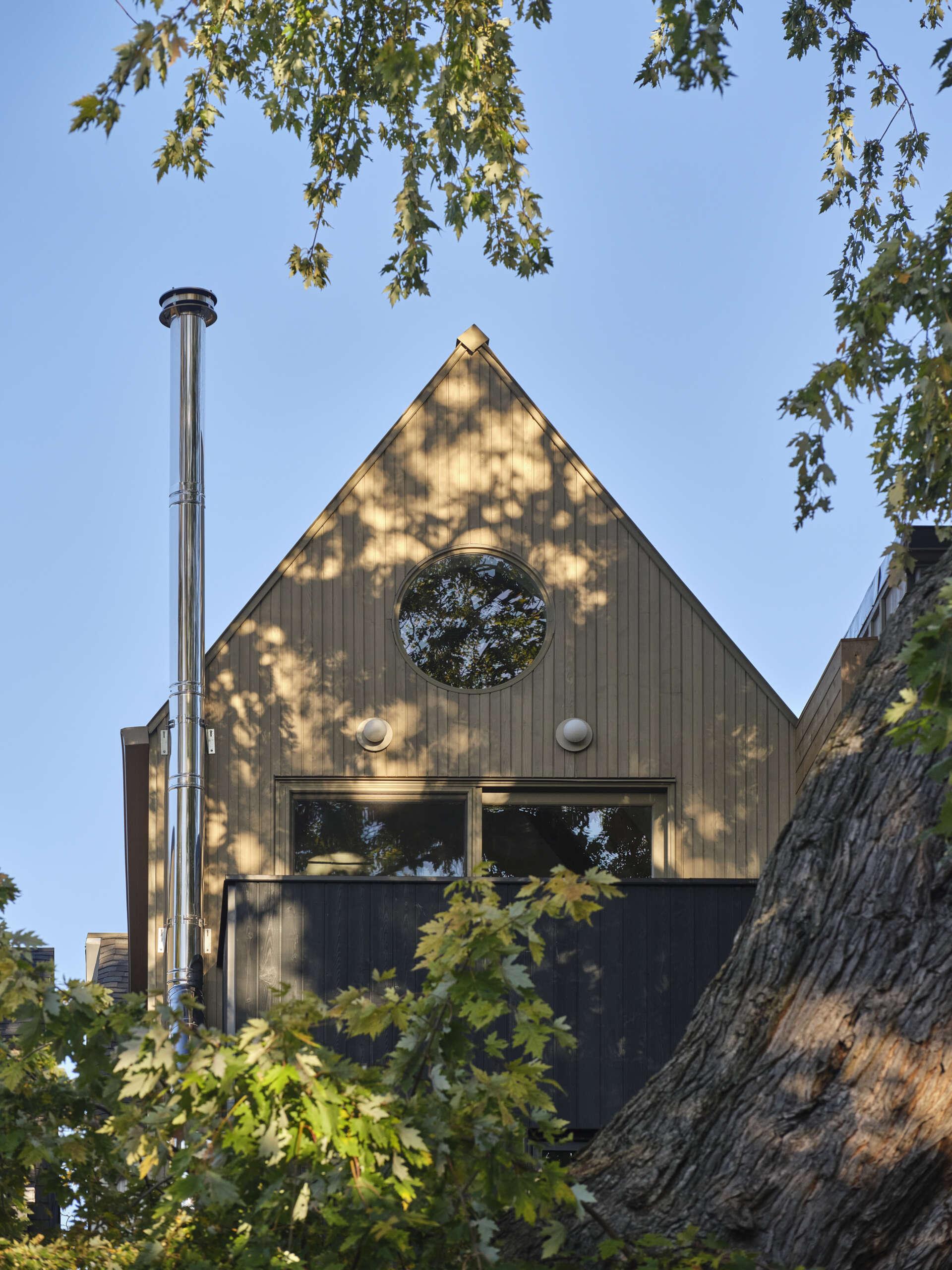 Discover a modern family home in Toronto that beautifully blends Victorian charm with a striking A-frame addition and warm natural materials.