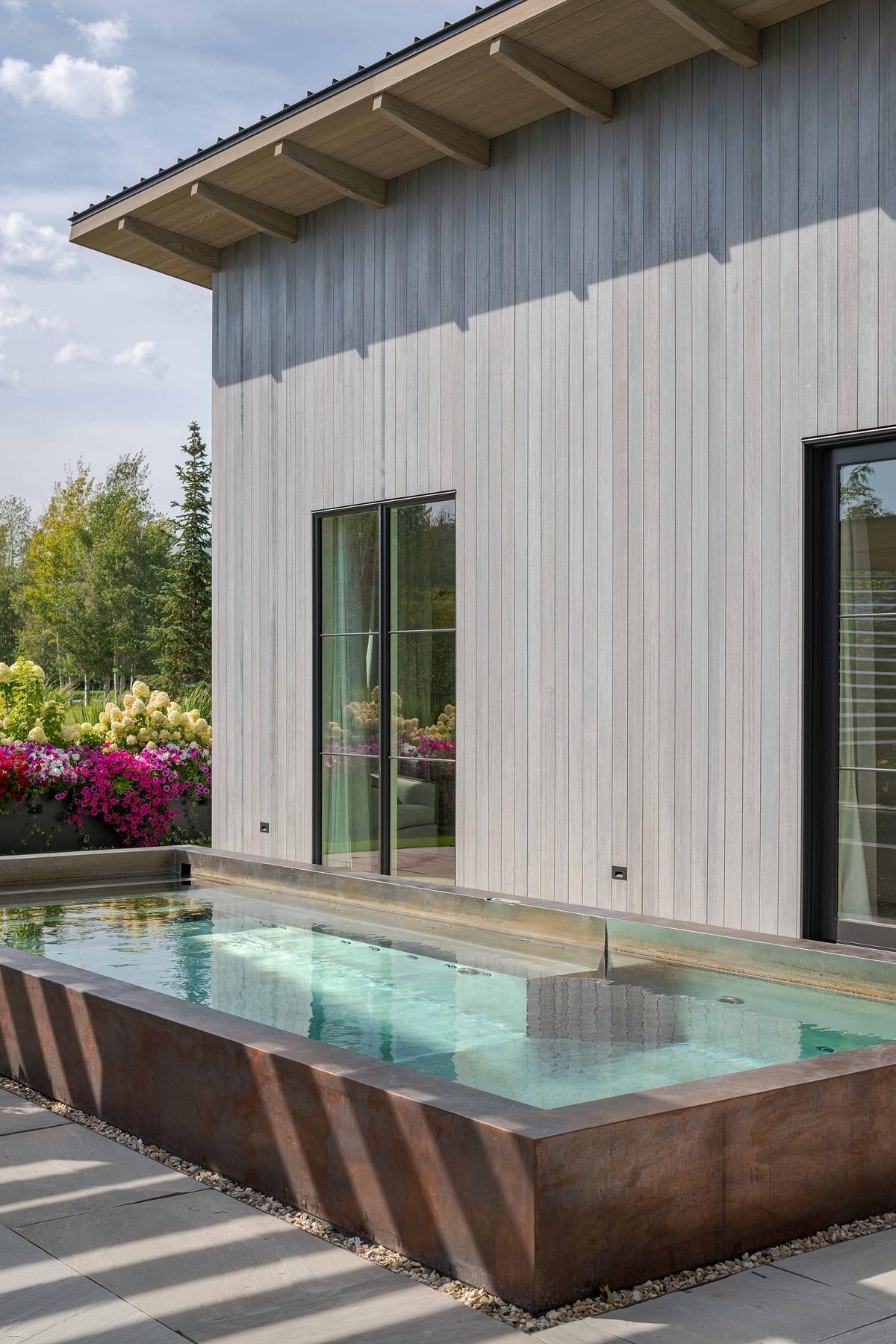 Native plantings, curated garden views, and layered outdoor spaces, like this pergola and lap pool, extend the home’s living area into the landscape with effortless grace.