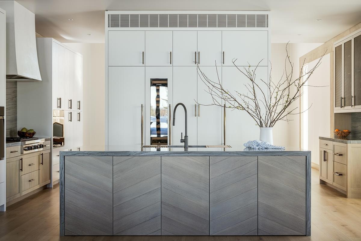 Warm wood tones and minimalist cabinetry define this thoughtfully designed kitchen, where subtle material choices support a clean, functional layout.