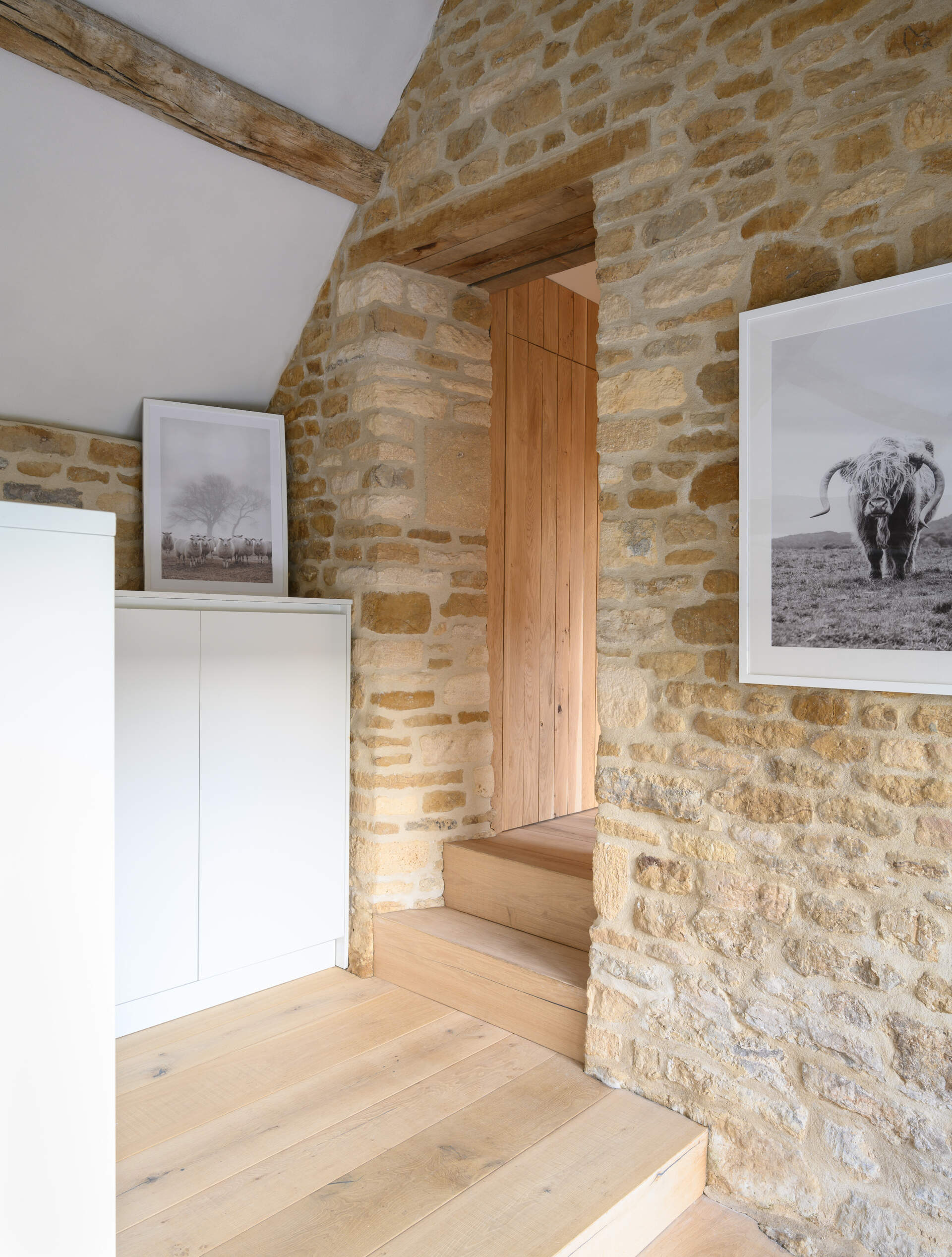 This boot room is quietly integrated into the plan, providing a spot to shake off muddy boots and stash outdoor gear. It reflects the same minimalist approach, with surfaces that can withstand daily wear while blending seamlessly into the house.