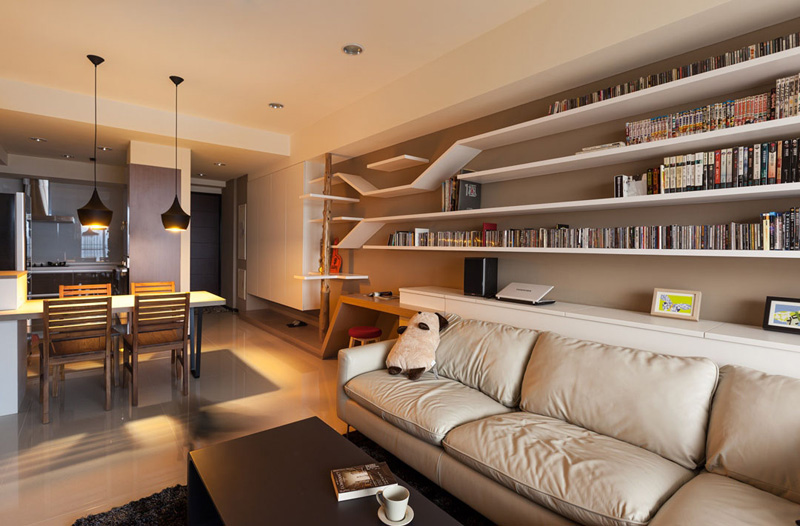 Explore a seamless catwalk built into a bookshelf, combining clever storage with elevated paths for cats to climb and explore. A wooden scratching post and discreet litter box complete this thoughtful design.